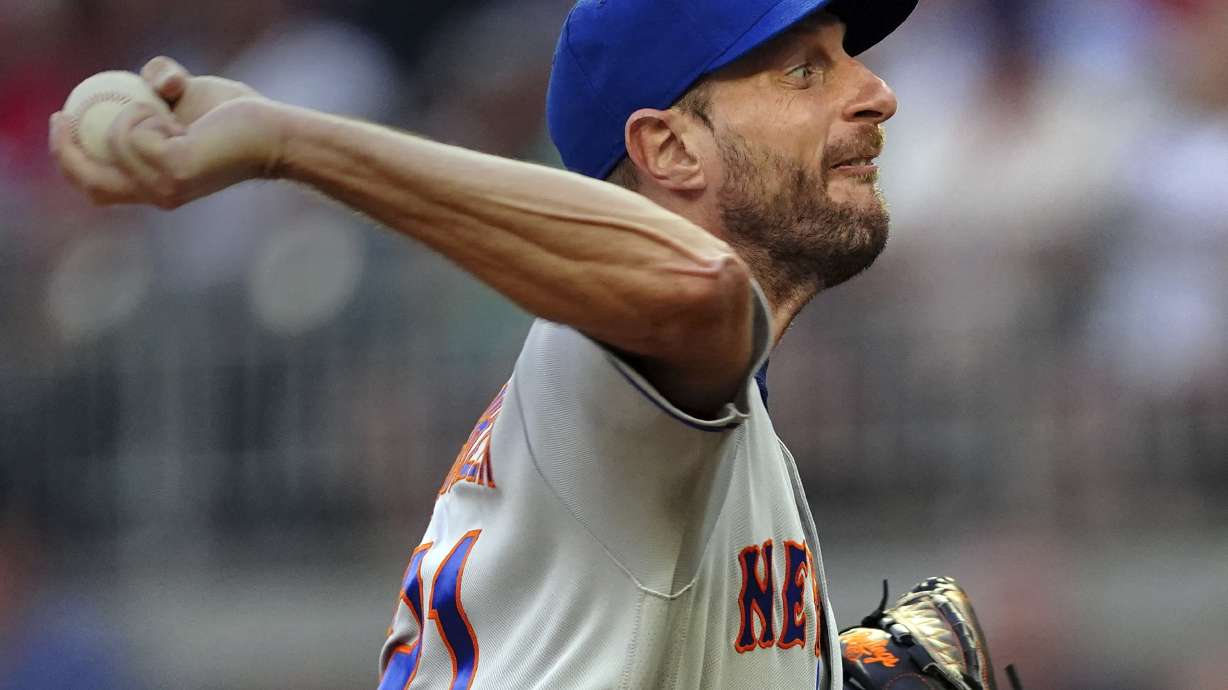 New York Mets starting pitcher Max Scherzer works against the Atlanta Braves in the third inning of a baseball game, Monday, July 11, 2022, in Atlanta.