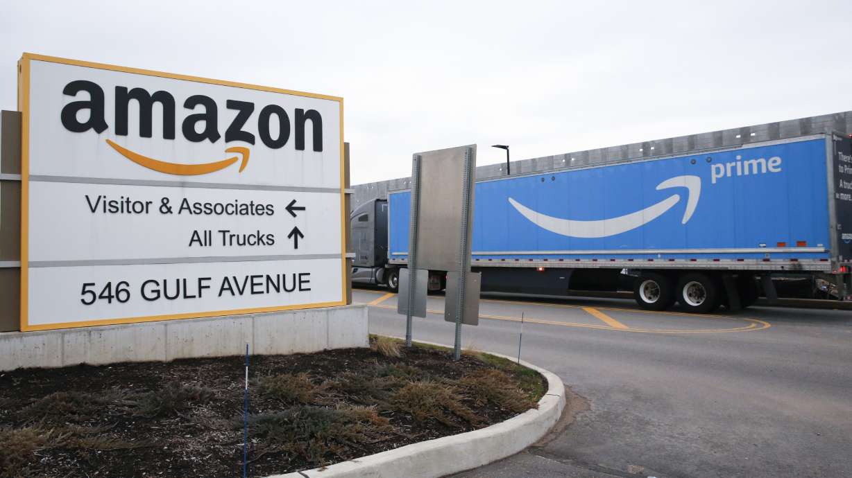 An Amazon Prime truck passes by a sign outside an Amazon fulfillment center on Staten Island, New York, on March 19, 2020. Amazon is heading into its annual Prime Day sales event on Tuesday, much differently than how it entered the pandemic.