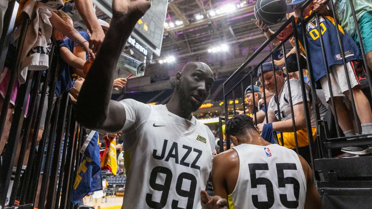 Tacko Fall (99), from the Utah Jazz, high-fives fans after a Salt Lake City Summer League game.
