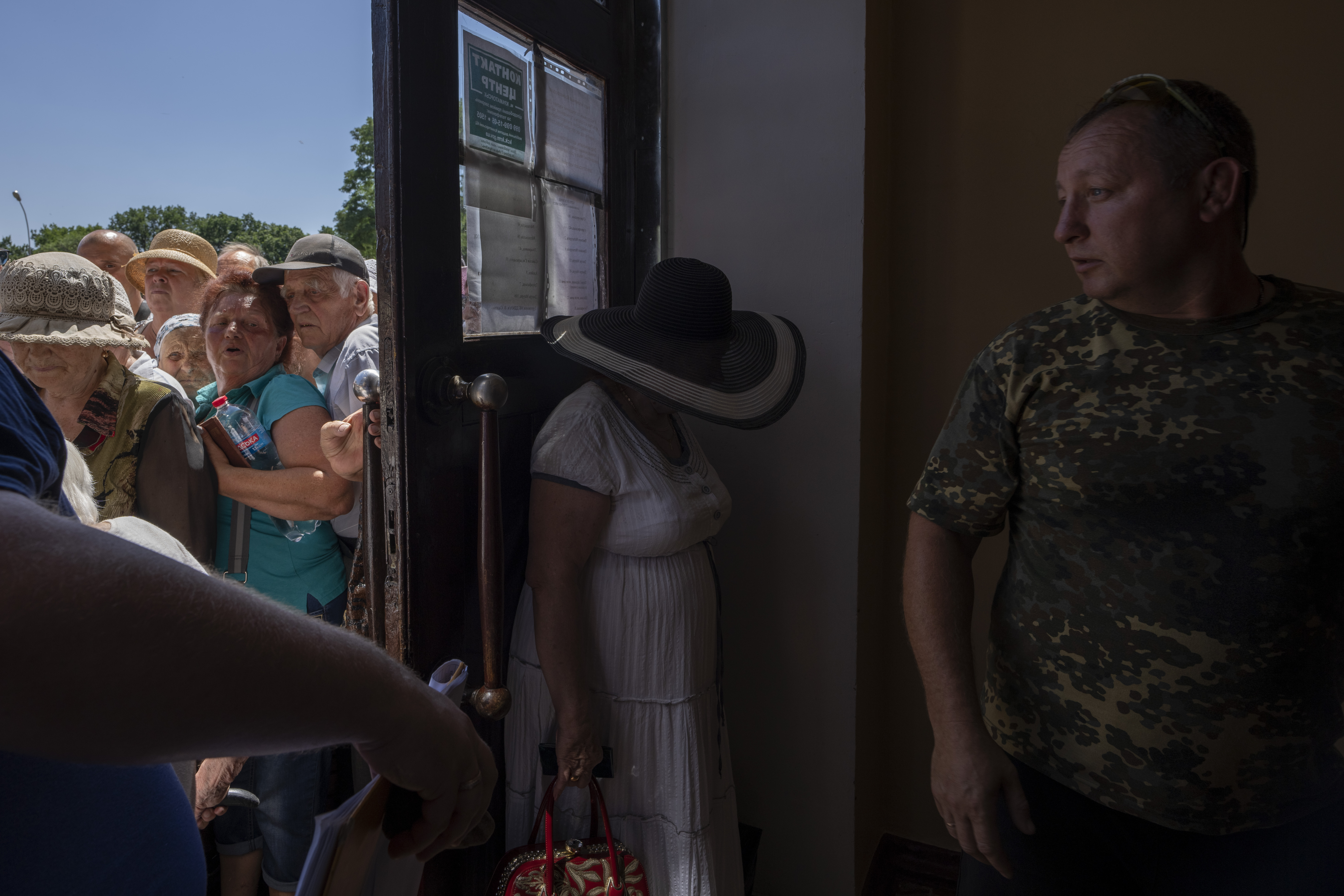People who mostly refuse to evacuate their homes, wait in line to receive humanitarian food aid from the Kramatorsk city council, eastern Ukraine, Thursday.