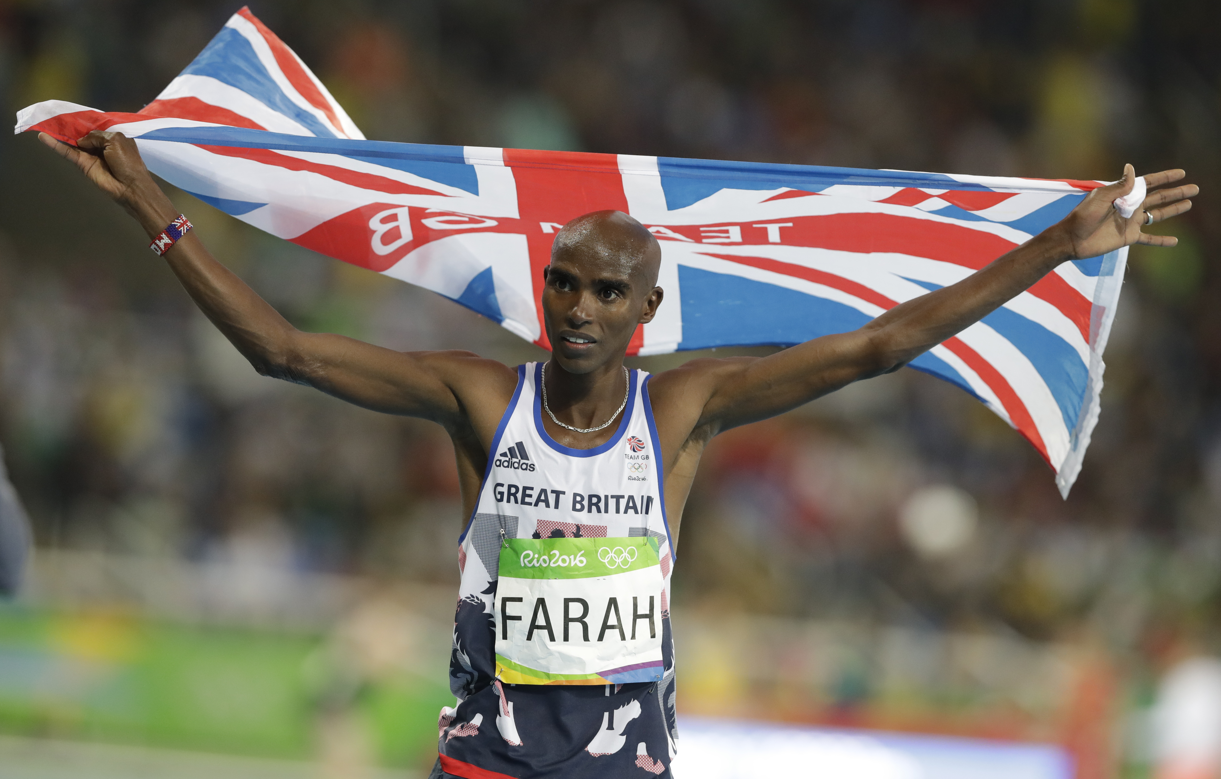 FILE - Britain's Mo Farah celebrates winning the gold medal in the men's 10,000-meter final during the athletics competitions of the 2016 Summer Olympics at the Olympic stadium in Rio de Janeiro, Brazil, Saturday, Aug. 13, 2016. Four-time Olympic champion Mo Farah has disclosed he was brought into Britain illegally from Djibouti under the name of another child. The British athlete made the revelation in a BBC documentary.