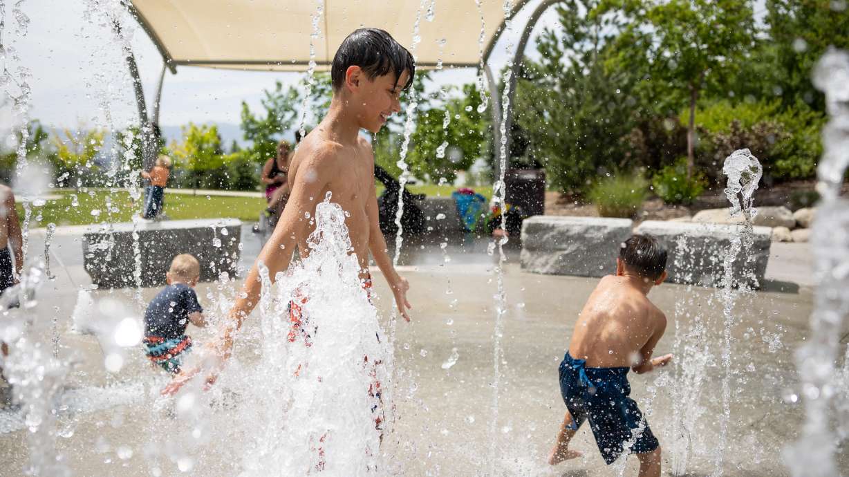 Dustin Perry, 9, center, and his brother, Dana Perry, 4, play in the water at the Amphitheater Park splash pad in Sandy on June 9. Most of the Wasatch Front is listed within an excessive heat warning between Tuesday afternoon and Thursday night.