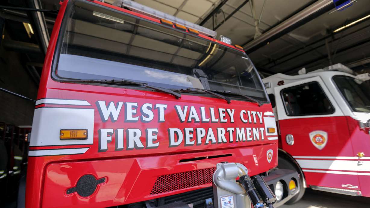 A West Valley firefighter remained hospitalized Tuesday with injuries he suffered after a stairwell collapsed as he and colleagues were carrying a patient down it on Monday.