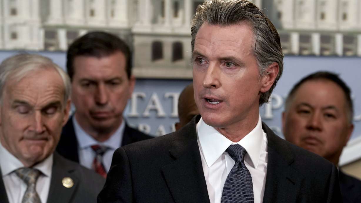 California Gov. Gavin Newsom, flanked by lawmakers, discusses the mass shooting in Texas, during a news conference in Sacramento, Calif., on May 25, 2022.