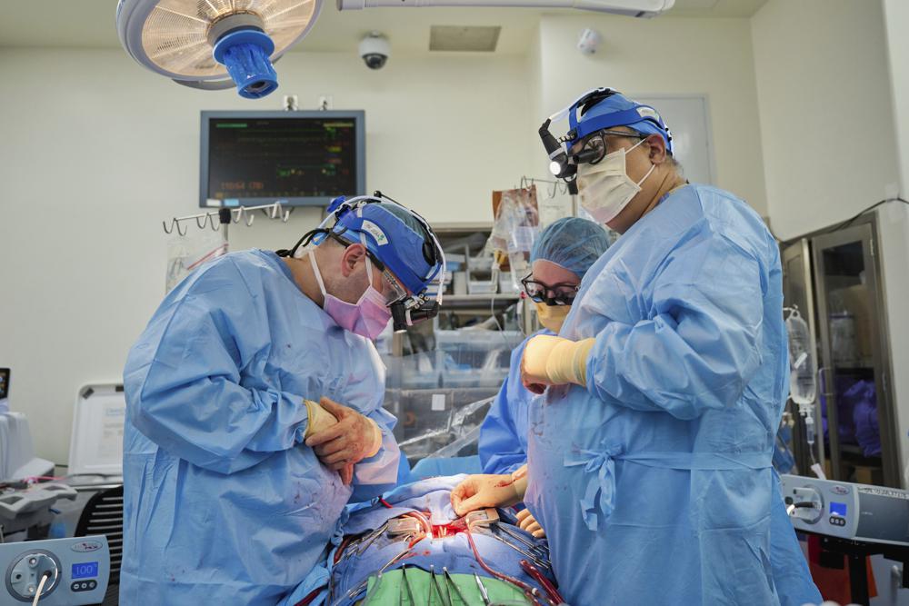 Dr. Nader Moazami, right, and cardiothoracic physician assistant Amanda Merrifield, center, and other members of a surgical team prepare for the transplant of a genetically modified pig heart into a recently deceased donor at NYU Langone Health on July 6 in New York.