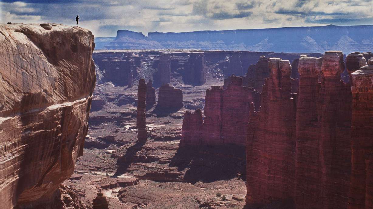 A hiker looks down at White Rim Trail in Canyonlands National Park, Monument Basin in file photo.
