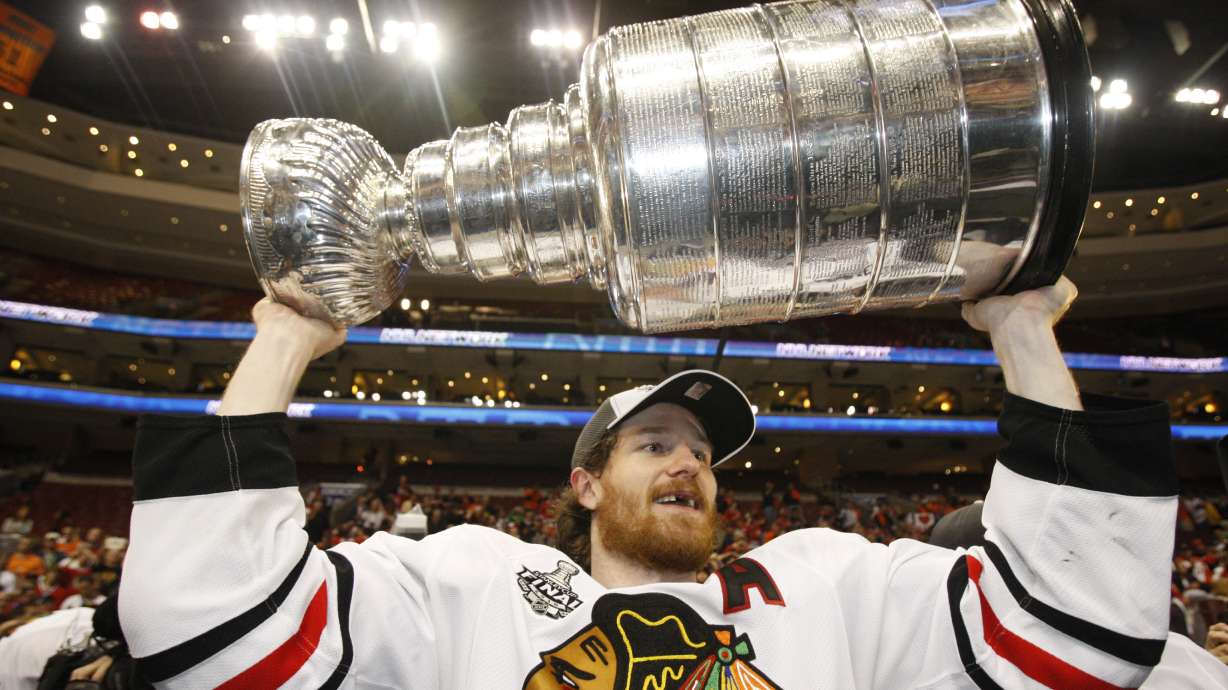 FILE - Chicago Blackhawks defenseman Duncan Keith lifts the Stanley Cup after the Blackhawks defeated the Philadelphia Flyers 4-3 in overtime to win Game 6 of the NHL Stanley Cup hockey final June 9, 2010, in Philadelphia. Keith is retiring after 17 seasons in the NHL, three Stanley Cups and two Norris Trophy awards as the league’s top defenseman. He spent most of his career with the Blackhawks and joined Edmonton last season.