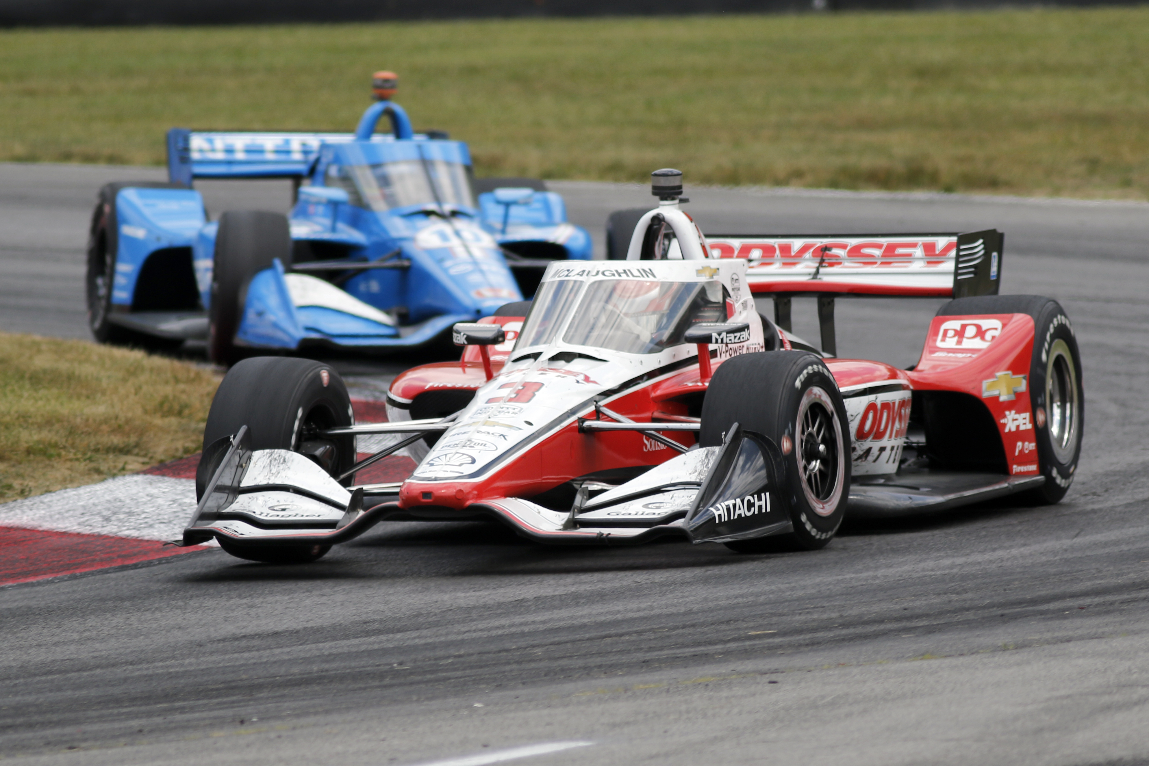 Scott McLaughlin leads Alex Palou through a corner during an IndyCar auto race at Mid-Ohio Sports Car Course in Lexington, Ohio, Sunday, July 3, 2022. 