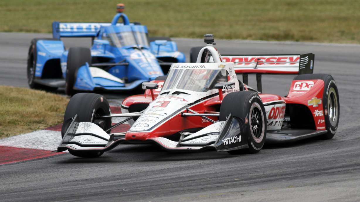 Scott McLaughlin leads Alex Palou through a corner during an IndyCar auto race at Mid-Ohio Sports Car Course in Lexington, Ohio, Sunday, July 3, 2022.