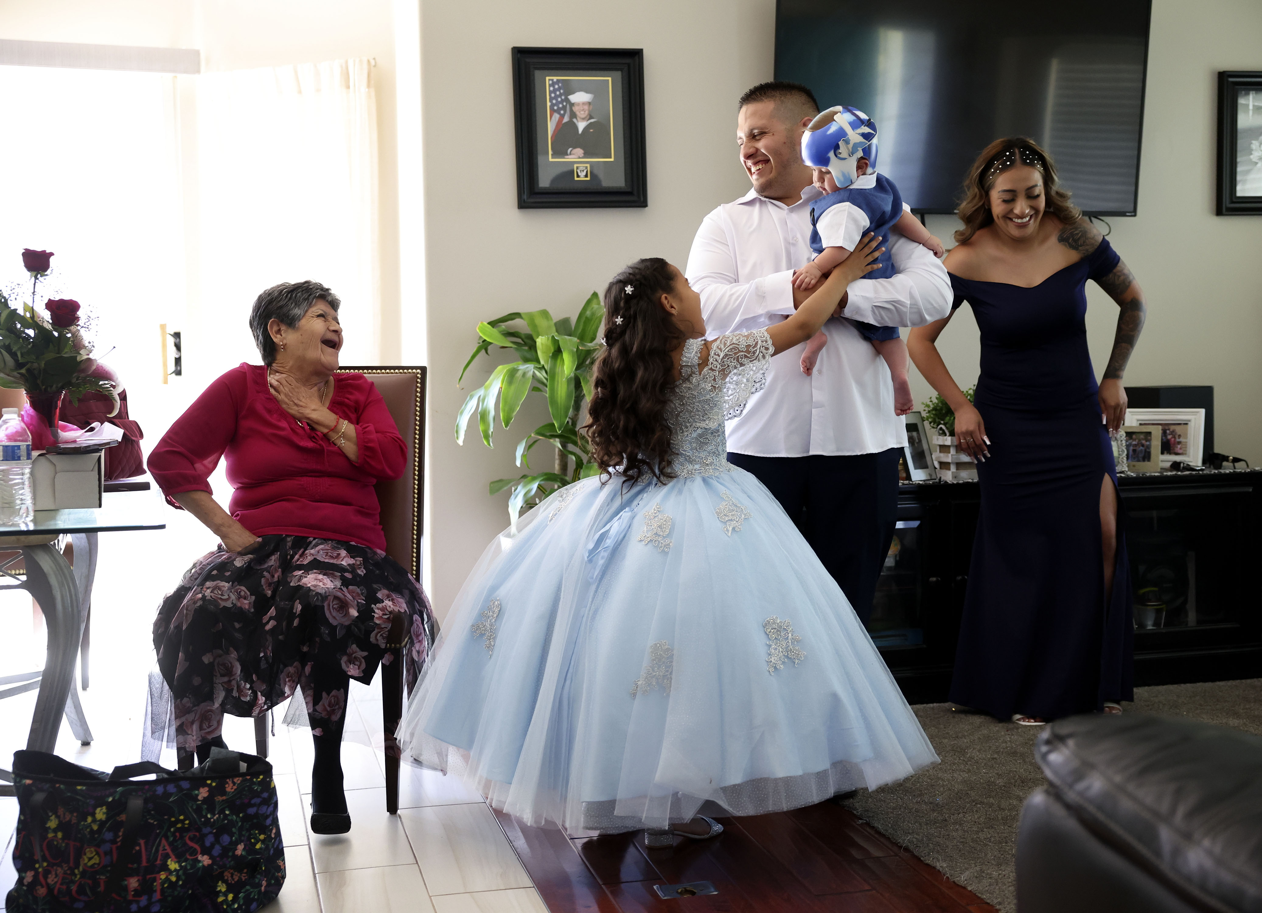 Rosa Perez, left, of Los Angeles, laughs with her great-granddaughter, Aundrea Martinez, 7, her grandson, Brian Martinez, who is holding Perez’s great-grandson, JJ Martinez, 6-months-old, and her granddaughter, Gabriela Gonzalez, as the family prepares for the quinceañara of Angelique Martinez in Taylorsville on July 8. Utah’s Hispanic population continues to be the fastest-growing demographic group in the state.