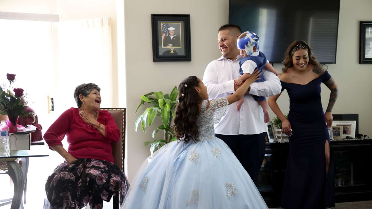 Rosa Perez, left, of Los Angeles, laughs with her great-granddaughter, Aundrea Martinez, 7, her grandson, Brian Martinez, who is holding Perez’s great-grandson, JJ Martinez, 6-months-old, and her granddaughter, Gabriela Gonzalez, as the family prepares for the quinceañara of Angelique Martinez in Taylorsville on July 8. Utah’s Hispanic population continues to be the fastest-growing demographic group in the state.