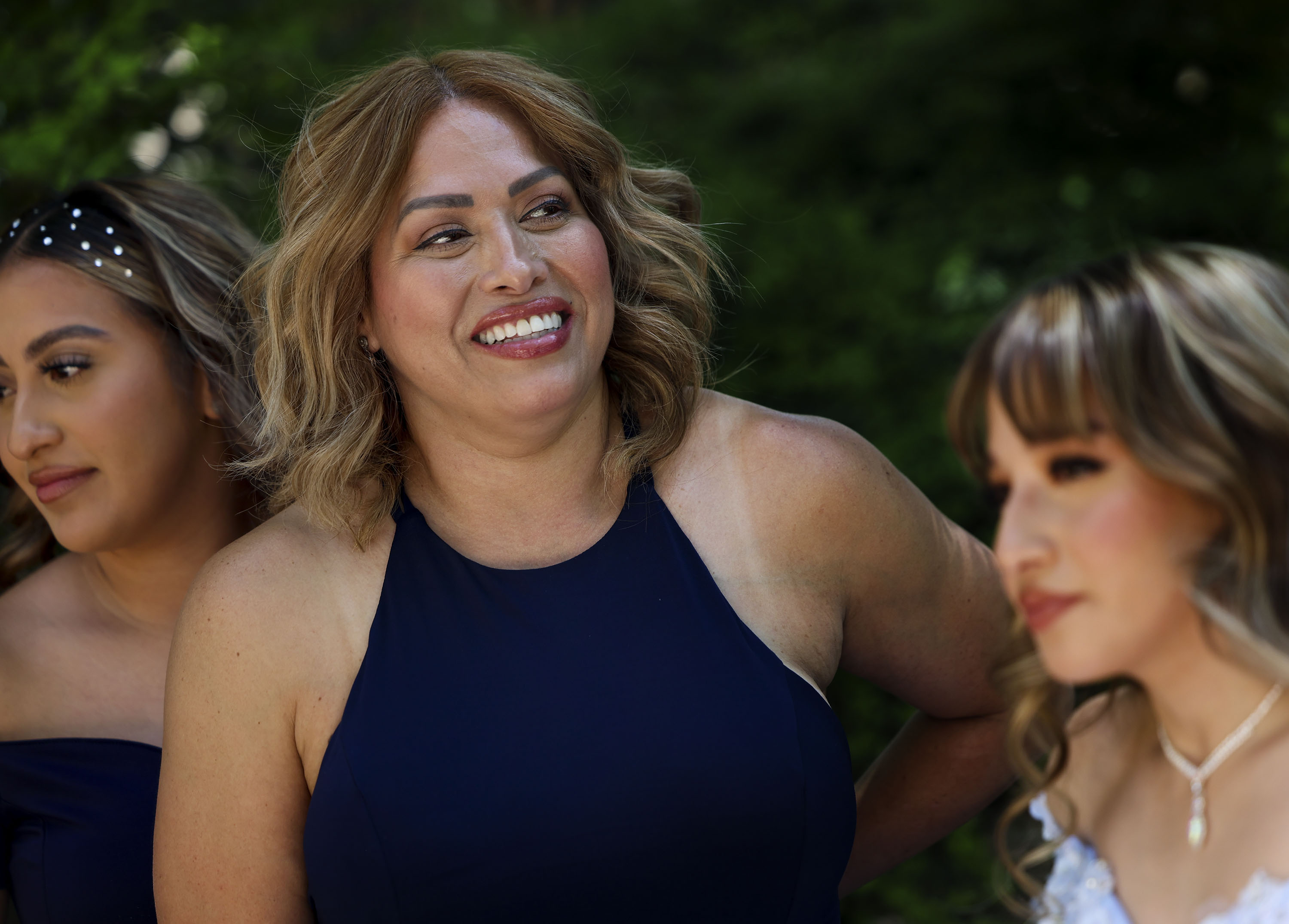 Rosa Gonzalez, center, stands with her daughters, Gabriela Gonzalez, left, and Angelique Martinez, right, during a photo session before Angelique’s quinceañera at in Salt Lake on Friday, July 8, 2022. Rosa Gonzalez and her husband Juan Martinez moved to Utah from Los Angeles 25 years ago because they felt it was the right place to raise a family. Gonzalez was was born in Chihuahua, Mexico, and moved to Los Angeles when she was 5-years-old.
