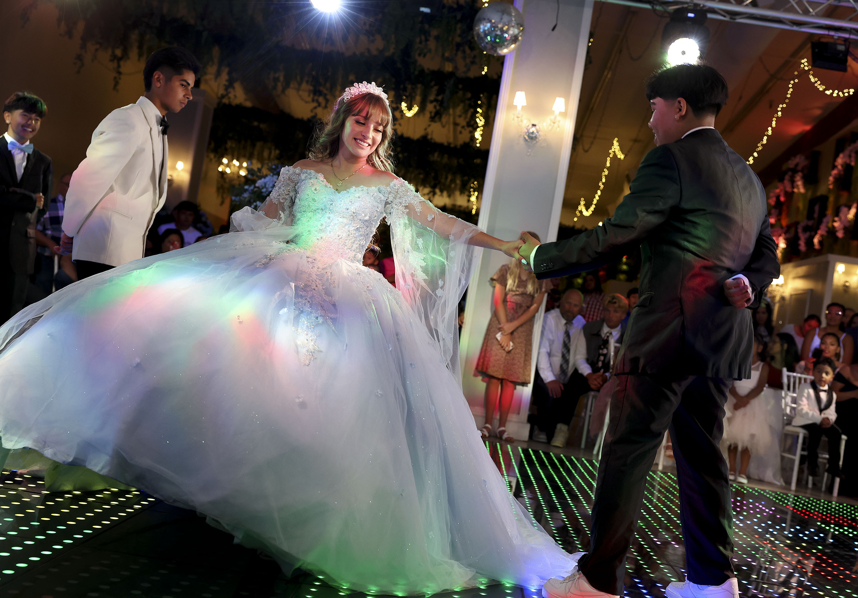 Angelique Martinez dances a waltz with her chambelanes during her quinceañera at Eventos in South Salt Lake on July 8. A quinceañera is the Hispanic tradition of celebrating a young girl's coming of age – her 15th birthday.