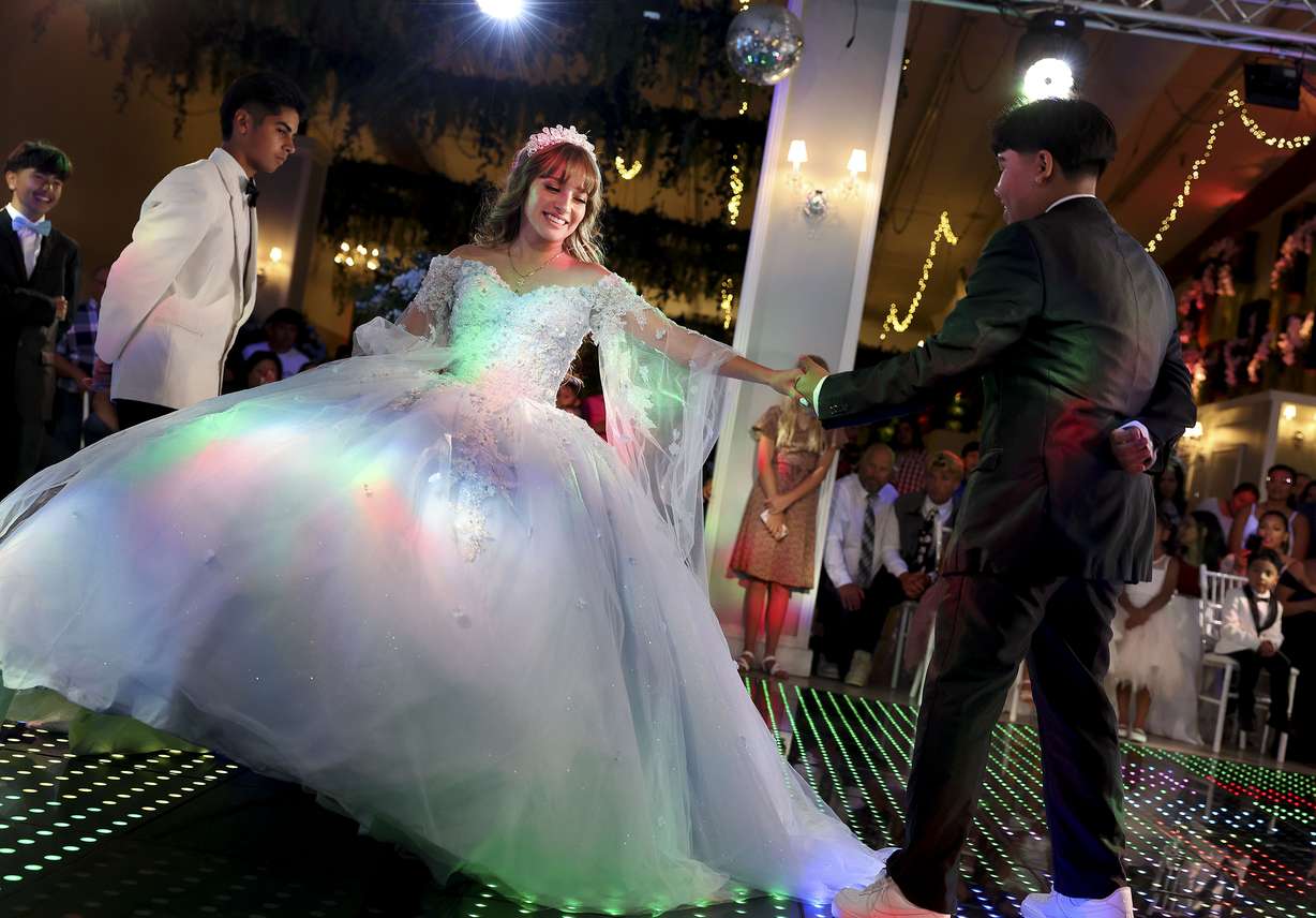 Angelique Martinez dances a waltz with her chambelanes during her quinceañera at Eventos in South Salt Lake on July 8. A quinceañera is the Hispanic tradition of celebrating a young girl's coming of age – her 15th birthday.