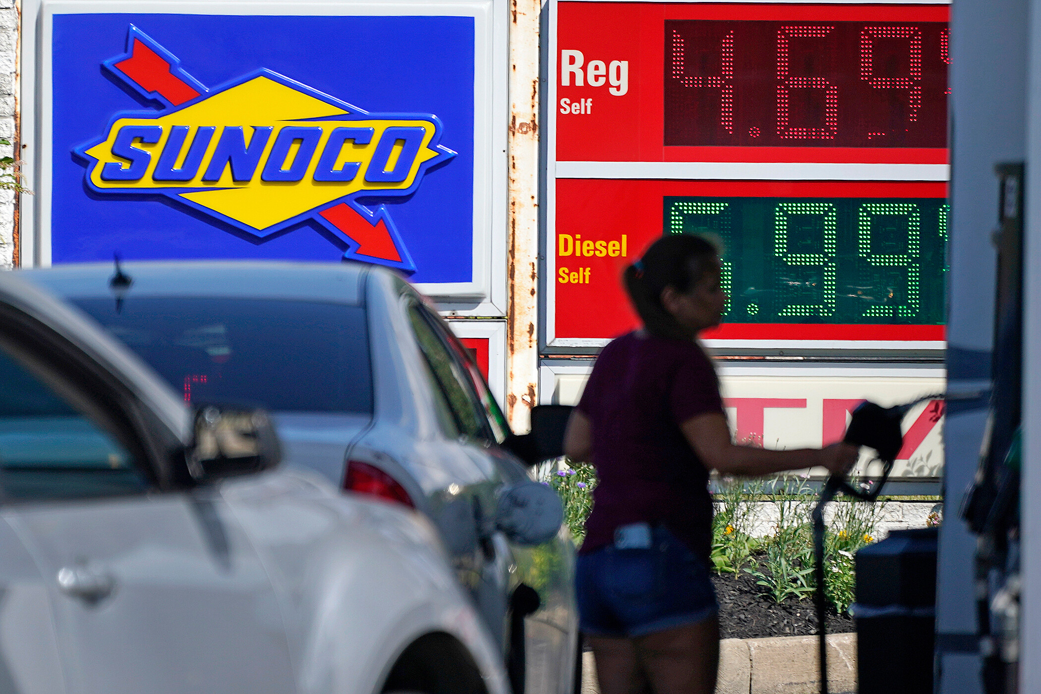 A woman pumps gas at a Sunoco mini-mart in Independence, Ohio, Tuesday. There are reasons not to panic despite the high inflation number reported Wednesday morning.