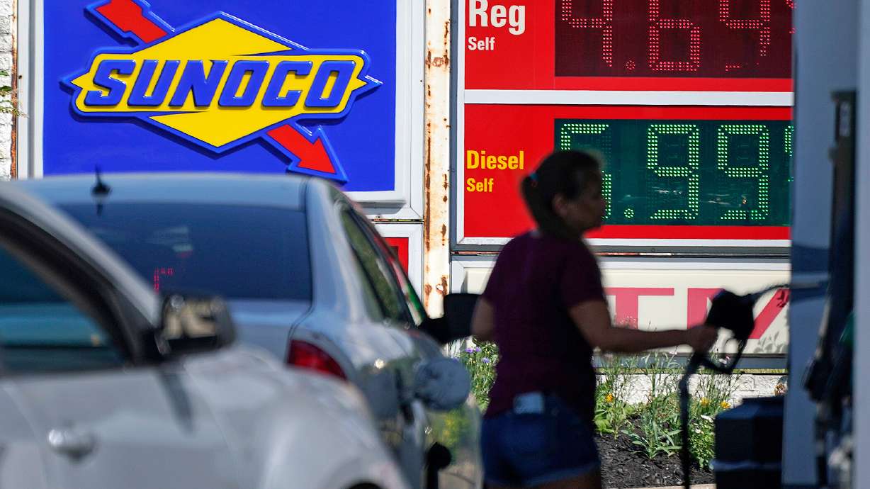 A woman pumps gas at a Sunoco mini-mart in Independence, Ohio, Tuesday. There are reasons not to panic despite the high inflation number reported Wednesday morning.