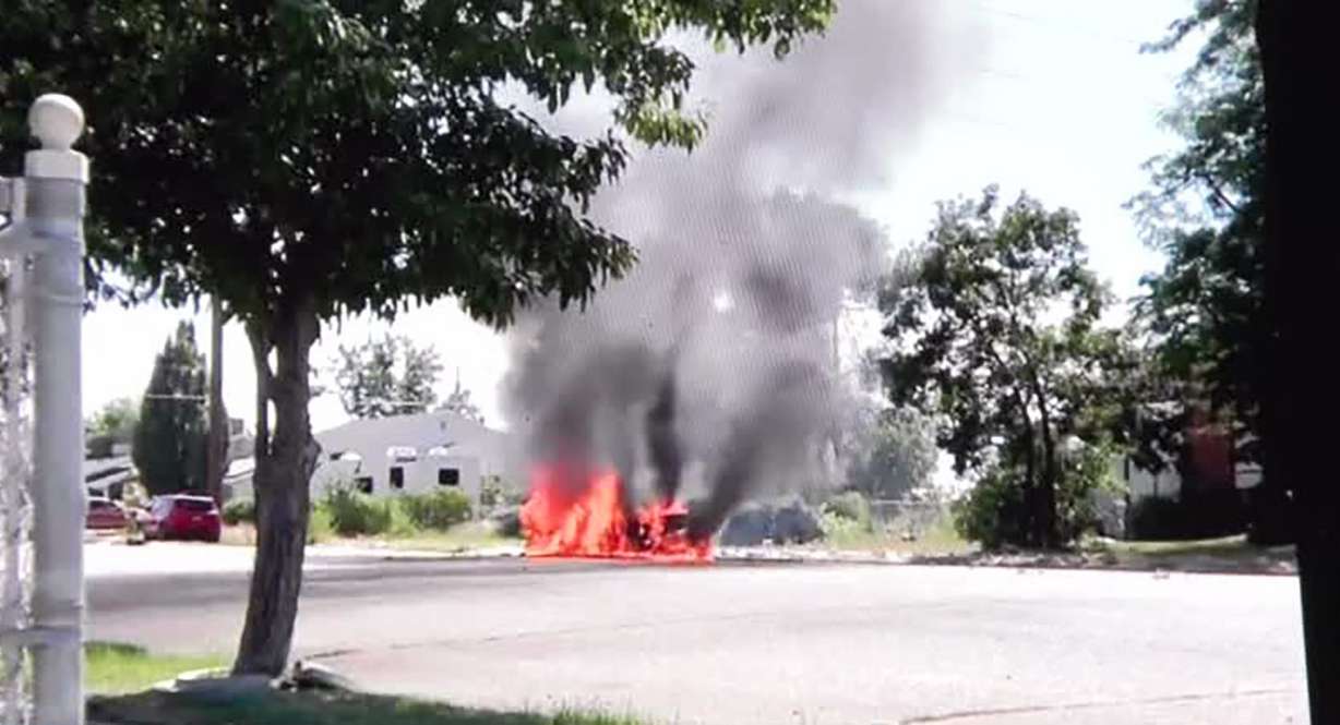 A car burns after Roy resident Doug Smith alerted the driver that it was on fire.