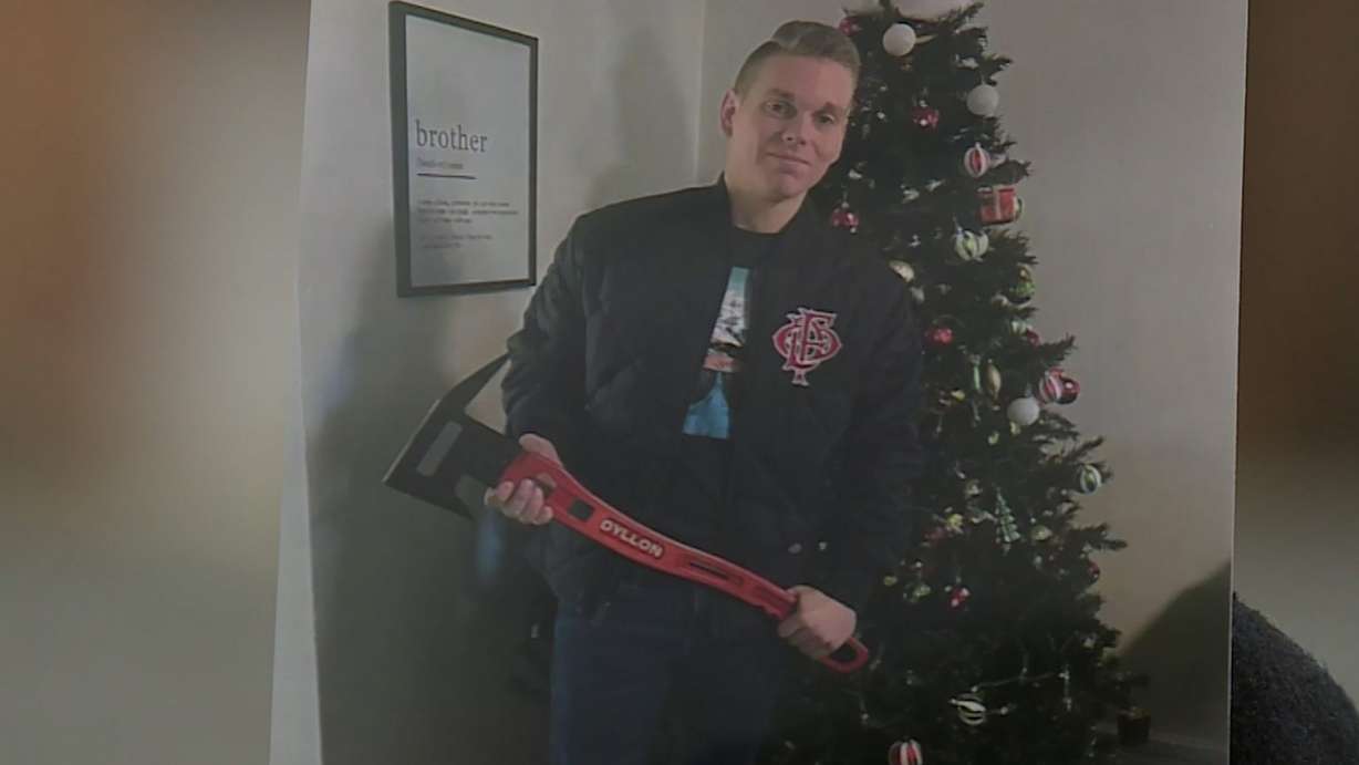 Ogden firefighter Dyllon Ryser receives gifts at a Christmas event.