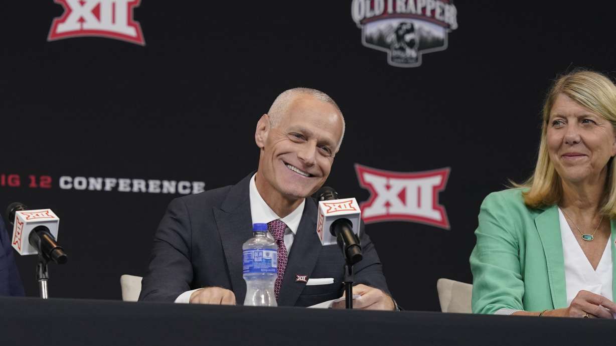Big 12 Commissioner Brett Yormark smiles during a news conference opening the NCAA college football Big 12 media days in Arlington, Texas, Wednesday, July 13, 2022. At right is Baylor President Linda Livingstone.