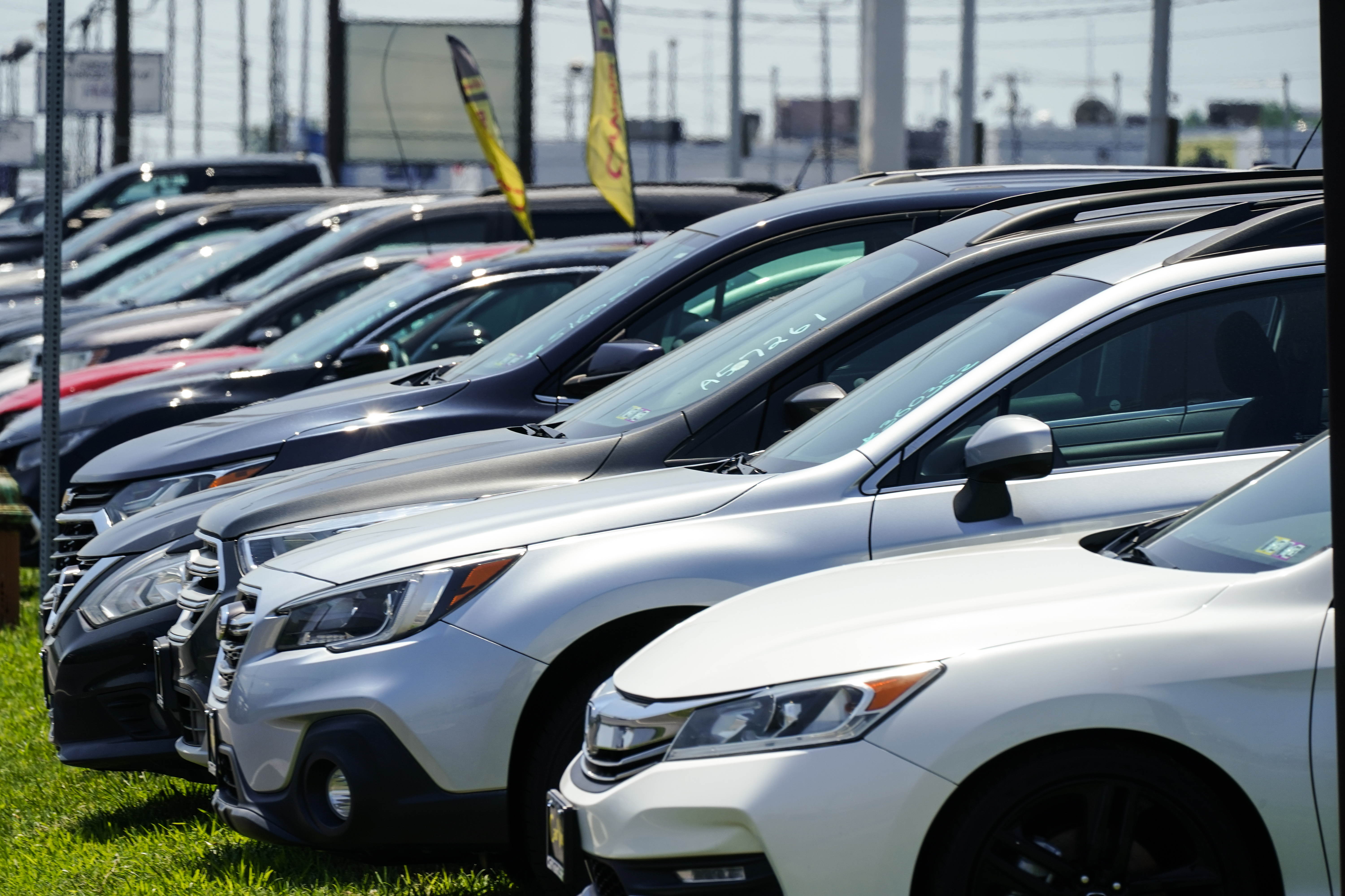 Used cars for sale are parked roadside at an auto lot in Philadelphia, Tuesday.
