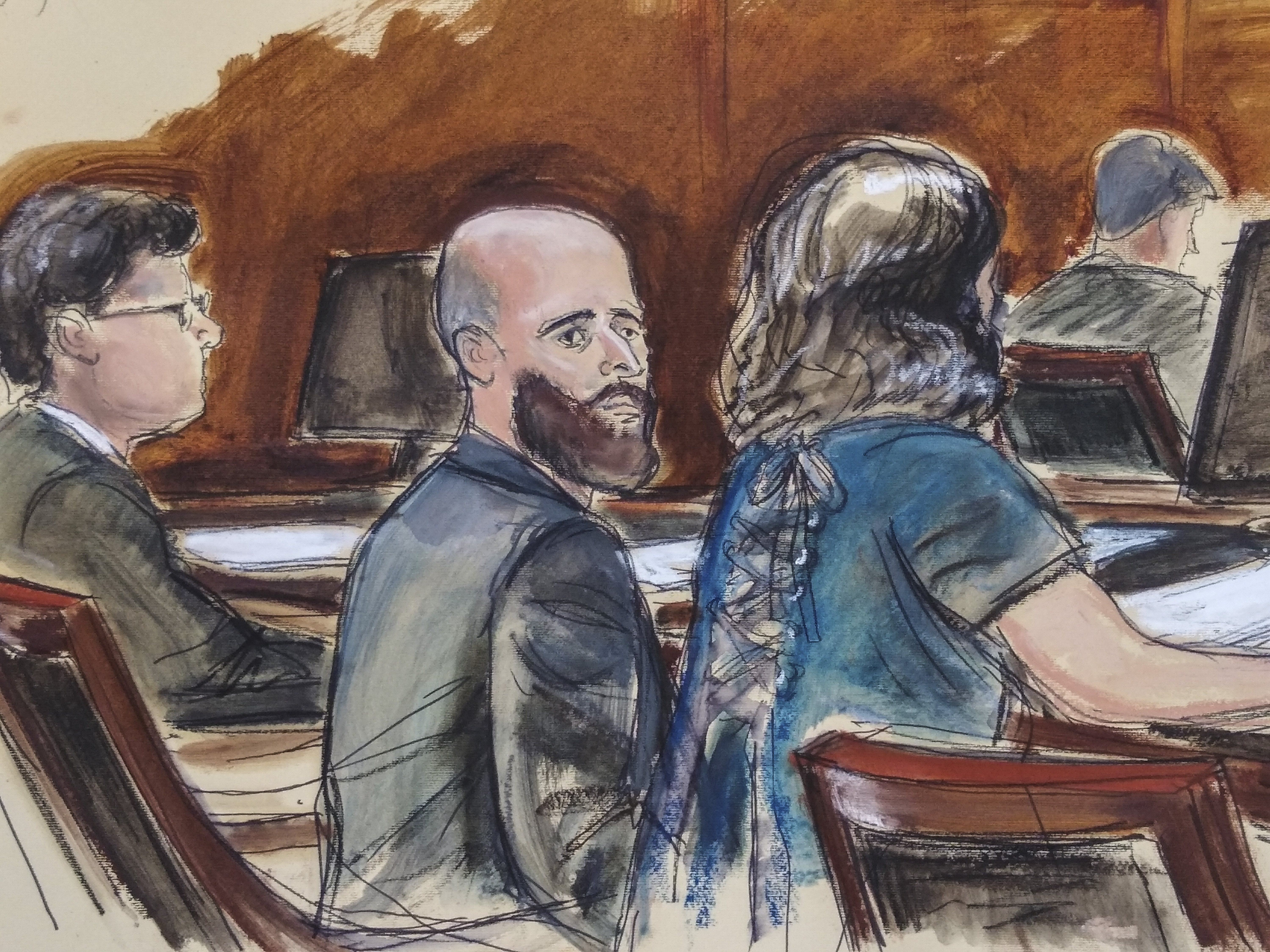 In this courtroom sketch, Joshua Schulte, center, is seated at the defense table flanked by his attorneys during jury deliberations on March 4, in New York. Schulte, a former CIA software engineer accused of causing the biggest theft of classified information in CIA history, has told a jury on July 7 there's not enough evidence to convict him, as he defended himself at a retrial. 