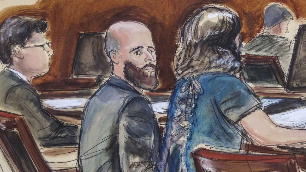 In this courtroom sketch, Joshua Schulte, center, is seated at the defense table flanked by his attorneys during jury deliberations on March 4, in New York. Schulte, a former CIA software engineer accused of causing the biggest theft of classified information in CIA history, has told a jury on July 7 there's not enough evidence to convict him, as he defended himself at a retrial.