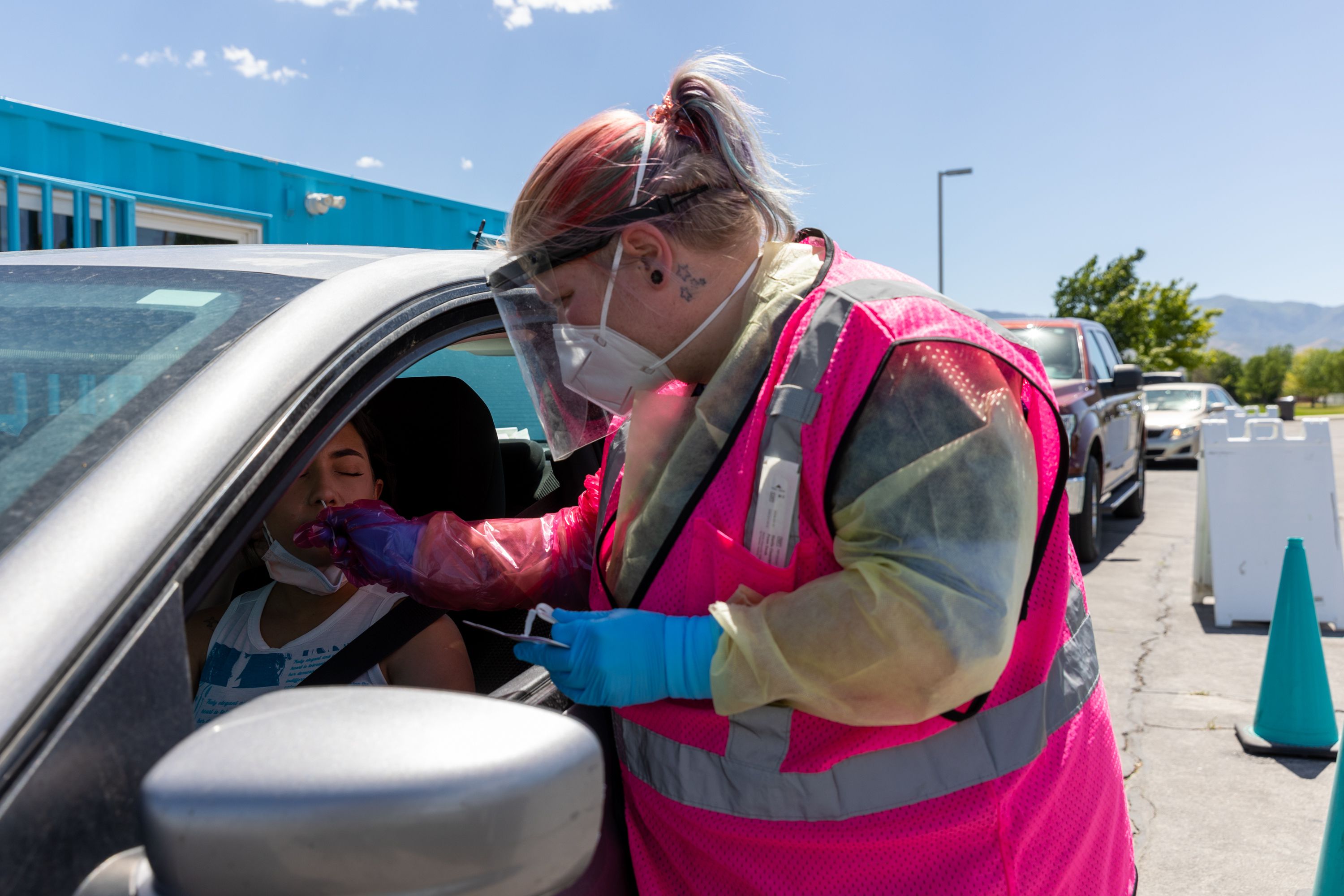 Megan Clay administers a COVID-19 test to Angel Alsammarraie in West Valley City on July 6. Utah health officials on Thursday reported 5,866 new COVID-19 cases and 16 additional deaths over the past week.