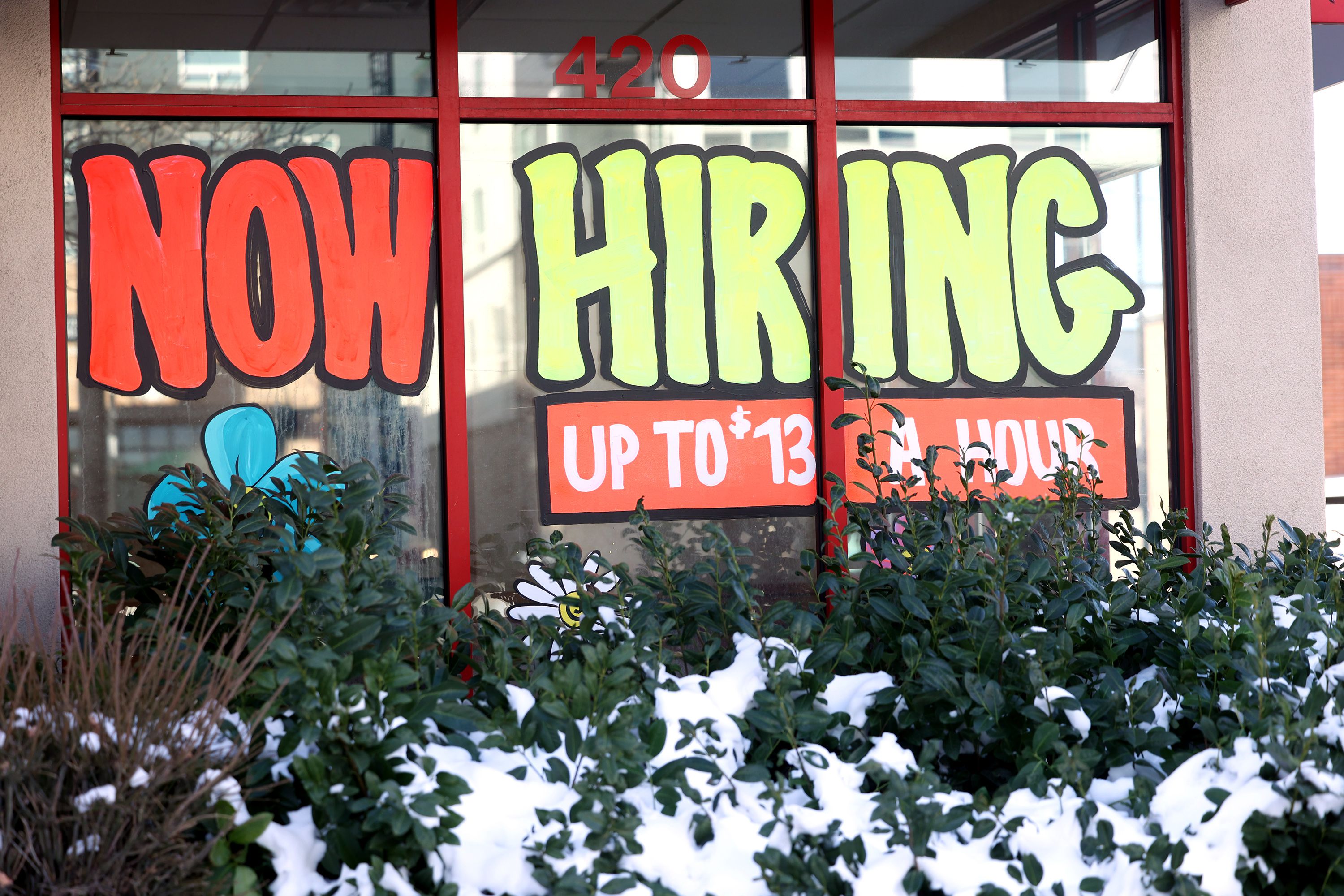 A “now hiring” sign at an Arby’s in Salt Lake City on Dec. 30, 2021, advertises wages of up to $13 per hour. The U.S. Labor Department says American workers are falling behind when it comes to their earnings.