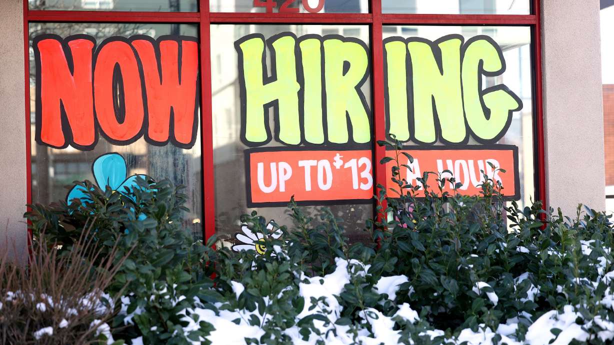 A “now hiring” sign at an Arby’s in Salt Lake City on Dec. 30, 2021, advertises wages of up to $13 per hour. The U.S. Labor Department says American workers are falling behind when it comes to their earnings.