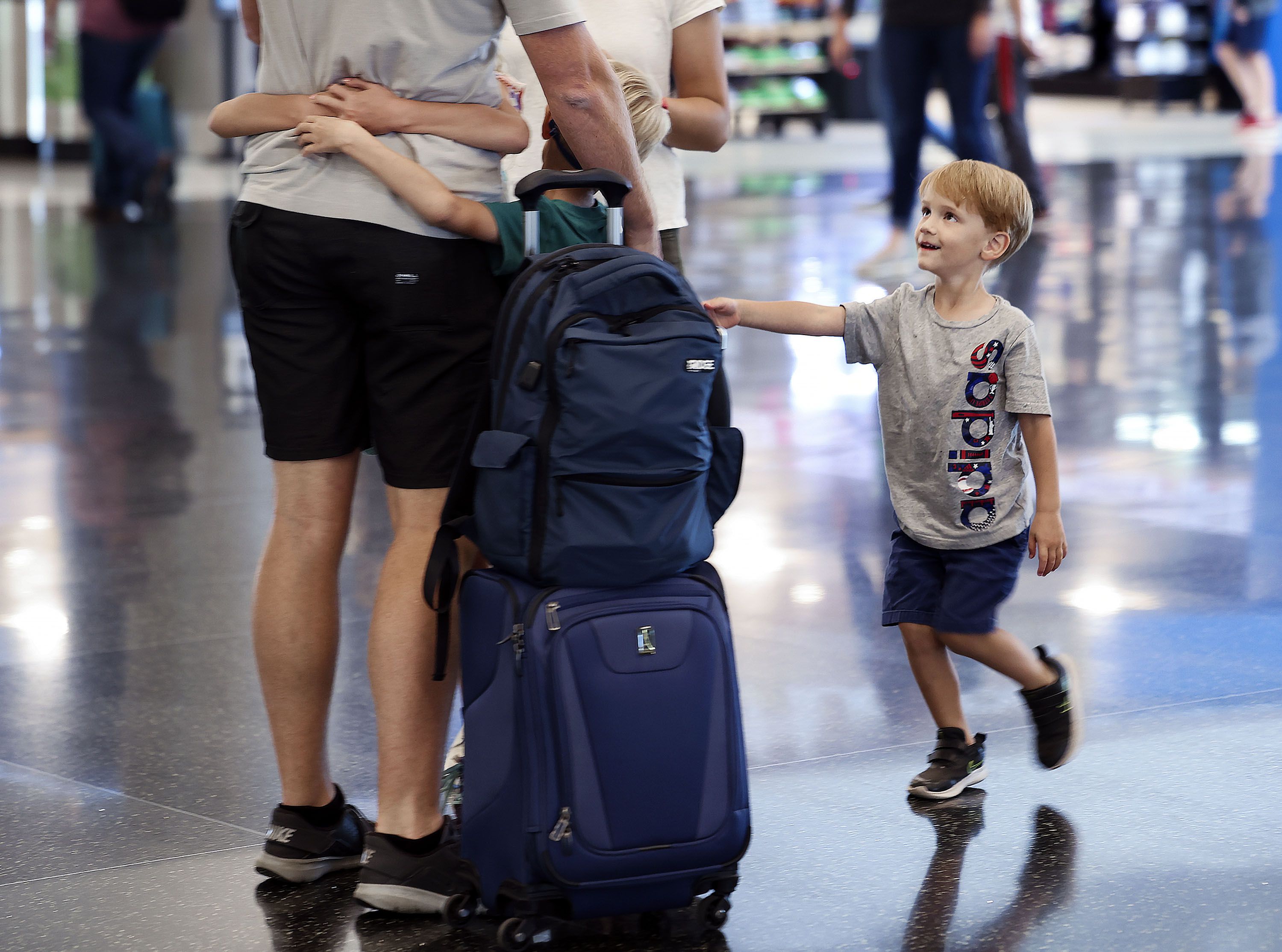 Jacob Cammack, right, of Draper, greets his father at the Salt Lake City International Airport on Wednesday. With summer travel demands causing flight cancellations and delays worldwide, London’s Heathrow Airport has capped the amount of daily passengers to 100,000 and has instructed airlines to stop selling tickets for the summer.