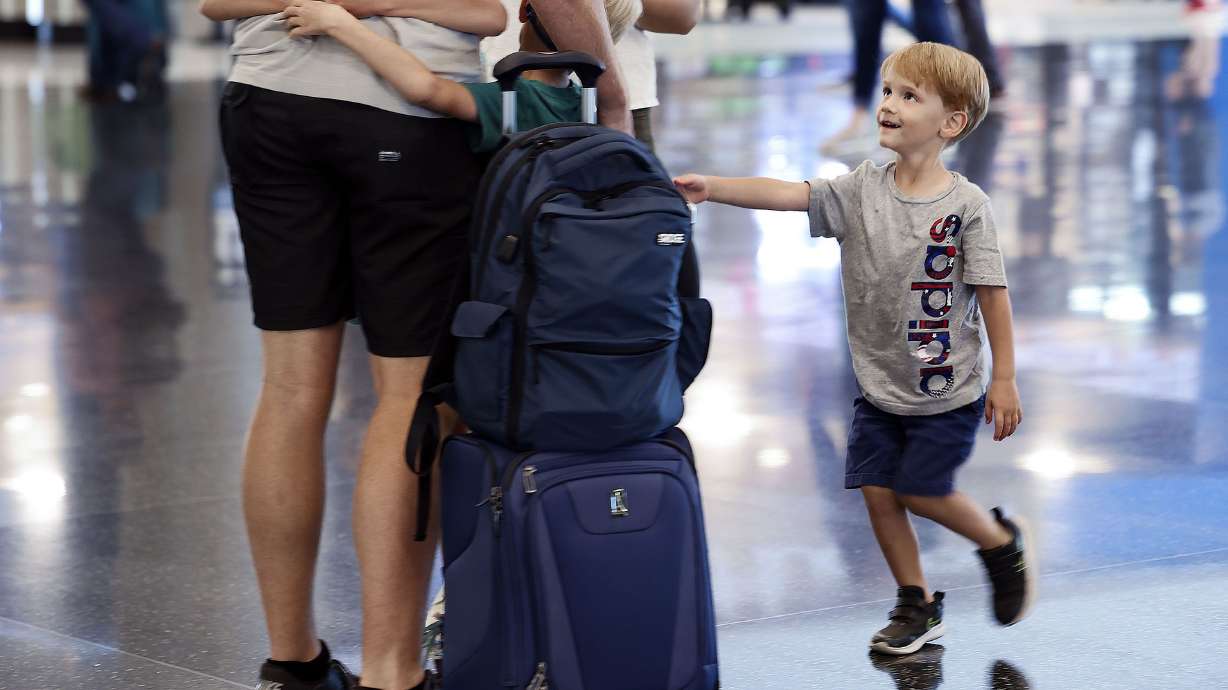 Jacob Cammack, right, of Draper, greets his father at the Salt Lake City International Airport on Wednesday. With summer travel demands causing flight cancellations and delays worldwide, London’s Heathrow Airport has capped the amount of daily passengers to 100,000 and has instructed airlines to stop selling tickets for the summer.
