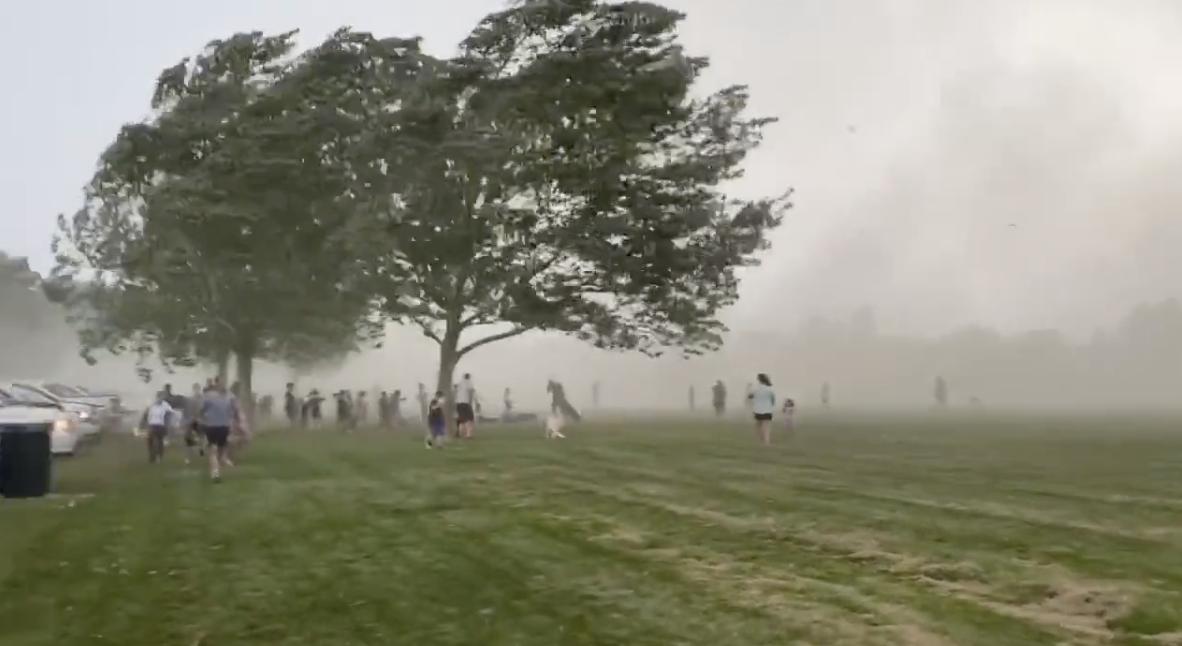 People flee Sandy City Park during a wind storm Wednesday.