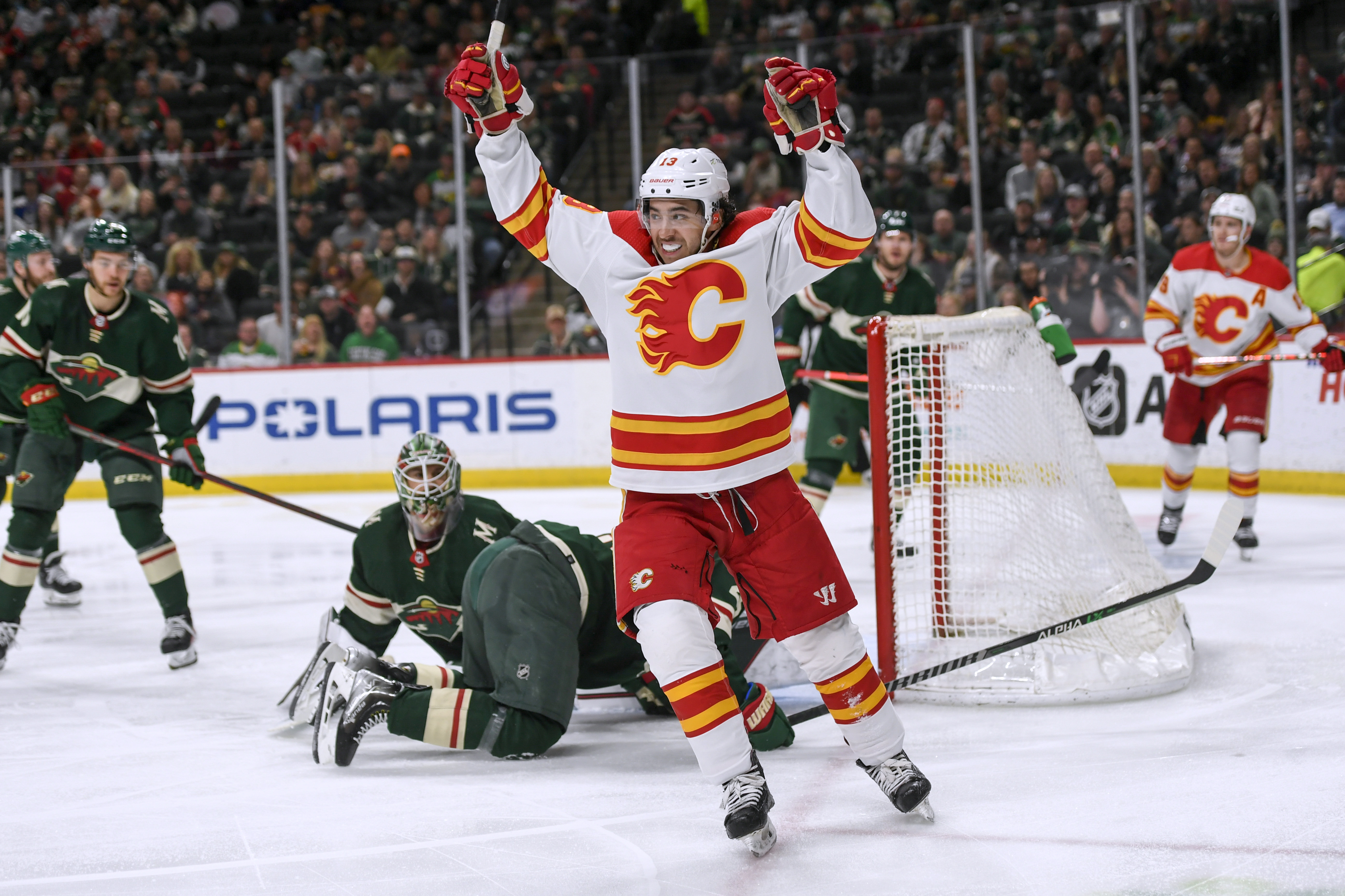 FILE - Calgary Flames left wing Johnny Gaudreau celebrates his goal on Minnesota Wild goalie Cam Talbot during the second period of an NHL hockey game Thursday, April 28, 2022, in St. Paul, Minn. The Columbus Blue Jackets made the biggest splash, stunning the league by landing Johnny Gaudreau with a seven-year contract for $68.25 million, Wednesday, July 13, 2022.