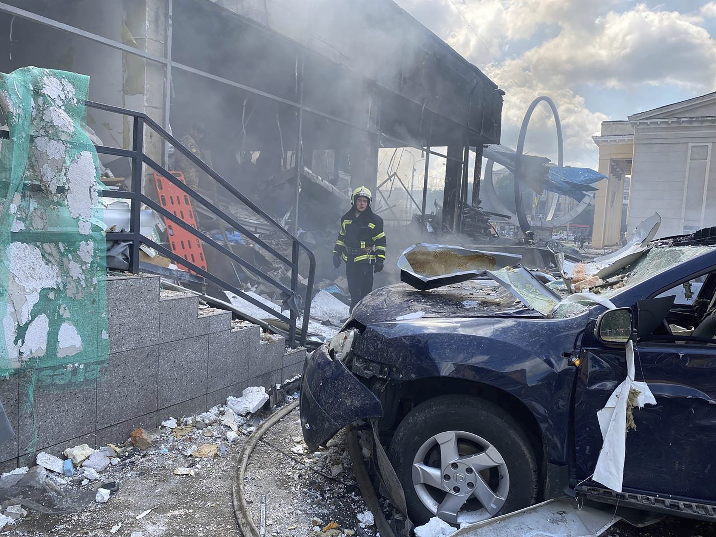 A firefighter stands among the damage after shelling in Vinnytsia, Ukraine, Thursday. Ukrainian officials say missiles killed at least 21 people.