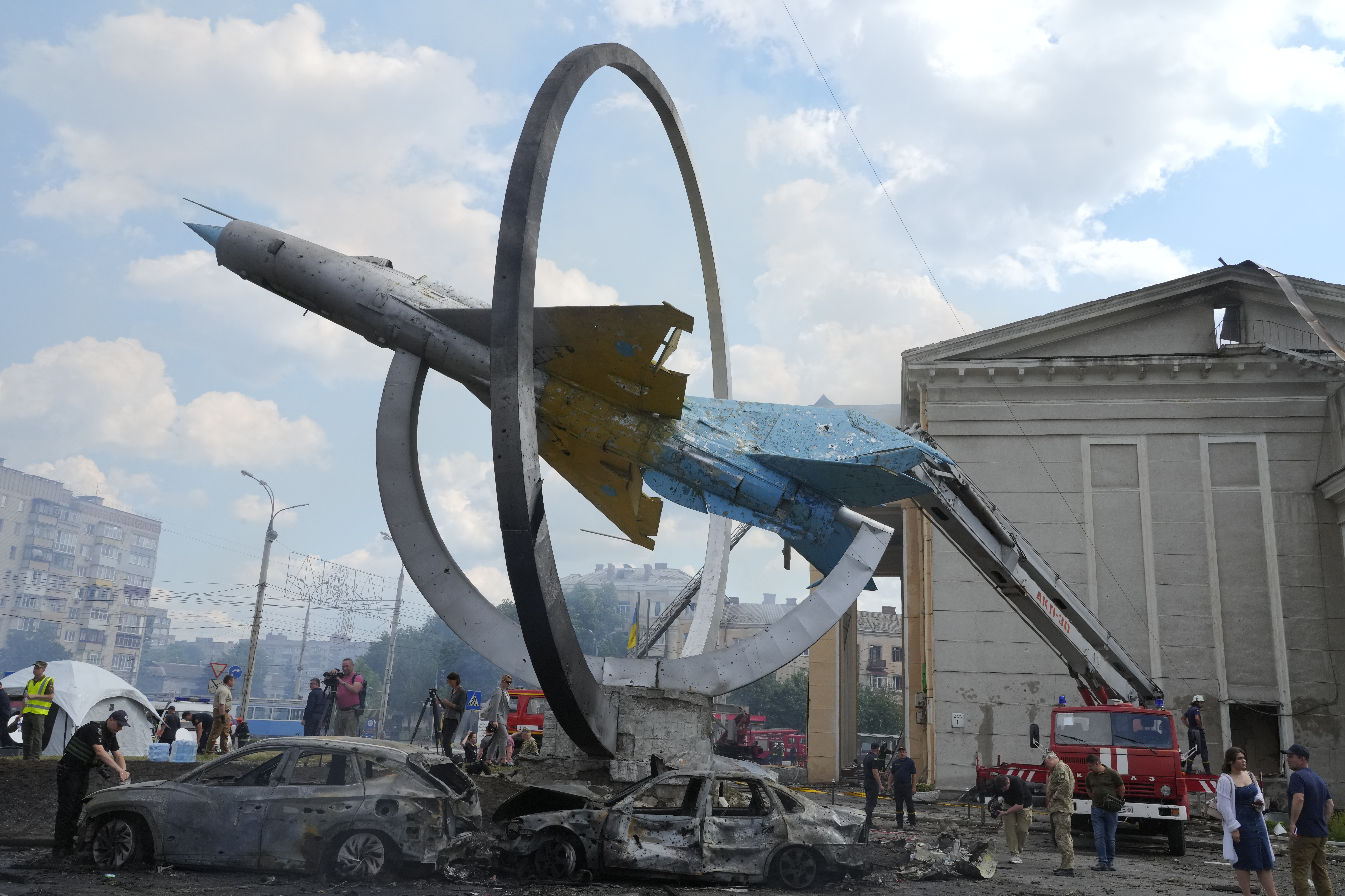 Damaged cars stand next to a Soviet fighter jet MiG-21, a monument in honour of the Air Forces of Ukraine, after shelling in Vinnytsia, Ukraine, Thursday.