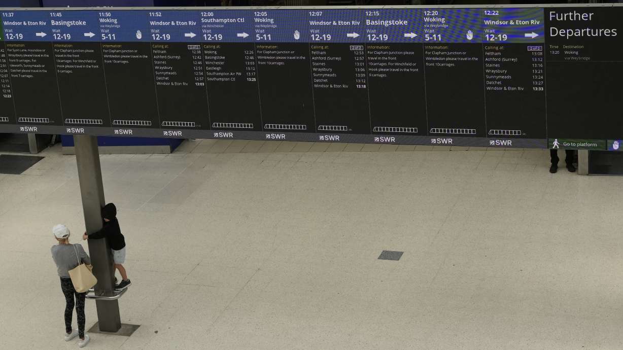 Train departure screens show which services are running, inside a much quieter than normal Waterloo railway station, in London, during a strike held by railway workers, Saturday, June 25, 2022. Train stations are all but deserted across Britain on the third day of a national strike that snarled the weekend plans of millions. Train companies said only a fifth of passenger services would run on Saturday.