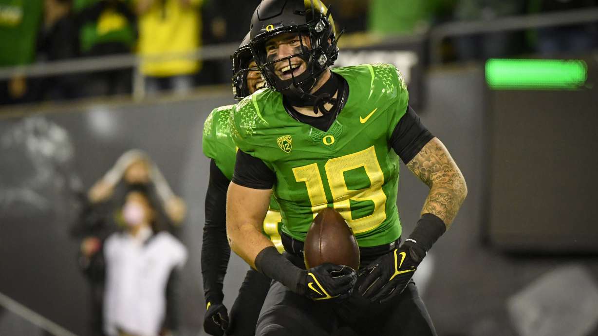 FILE - Oregon Ducks tight end Spencer Webb (18) is shown after a touchdown during an NCAA college football game against Arizona on Sept. 25, 2021, in Eugene, Ore. Webb has died after falling and striking his head on rock slides at a popular swimming lake near Eugene, Oregon. Authorities say the 22-year-old was unresponsive when they arrived at Triangle Lake on Wednesday, July 13, 2022, and found him about 100 yards down a steep trail.