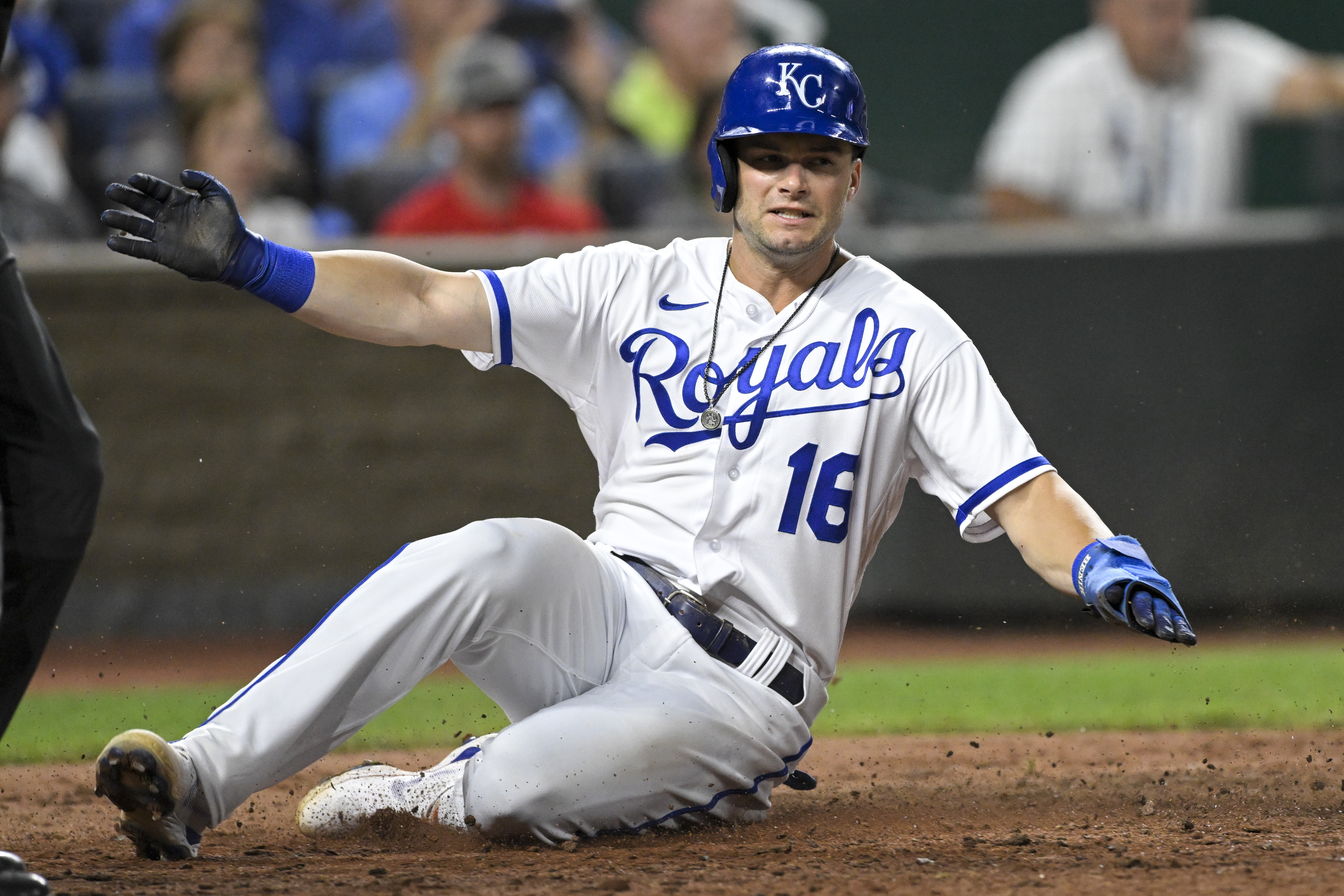 Kansas City Royals' Andrew Benintendi slides across home plate to score against the Detroit Tigers during the eighth inning of a baseball game, Tuesday, July 12, 2022, in Kansas City, Mo. 