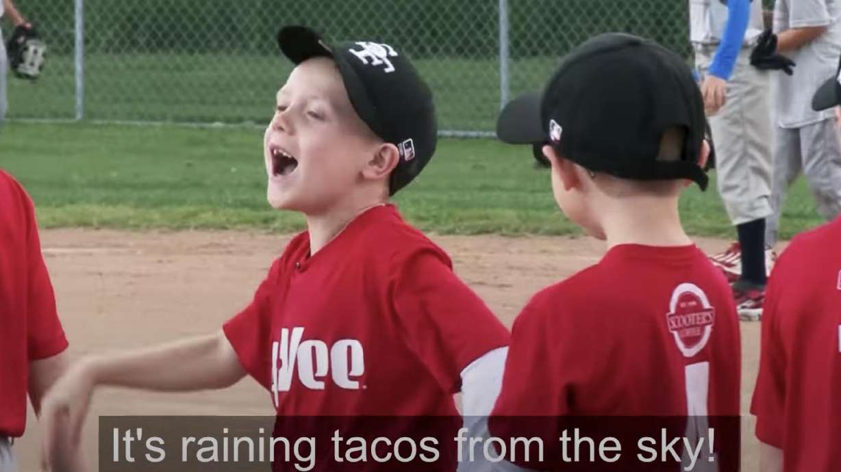 A screenshot from video by Chad Hunt featuring his two boys mic'd up during a youth baseball game.