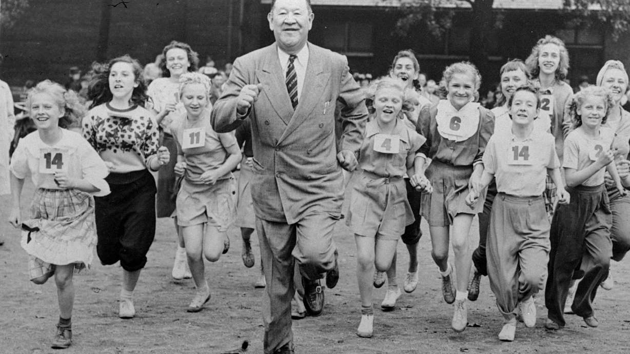 FILE - Big Jim Thorpe, famed American athlete and former U.S. Olympic great, center, sets a fast pace for some girls during a "junior olympics" event on Chicago's south side June 6, 1948 sponsored by a V.F.W. post. Jim Thorpe has been reinstated as the sole winner of the 1912 Olympic pentathlon and decathlon — nearly 110 years after being stripped of those gold medals for violations of strict amateurism rules of the time. The International Olympic Committee confirmed that an announcement was planned later Friday, July 15, 2022.