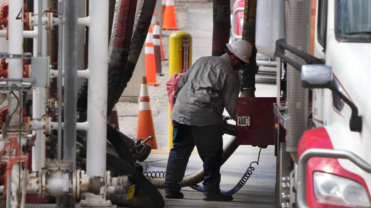 A driver hooks hoses up to fill his tanker with gas and diesel on May 24, in Salt Lake City, Utah. America consumed about 128 million gallons of diesel a day in 2021, according to the U.S. Energy Information Administration, but production hasn't kept up.