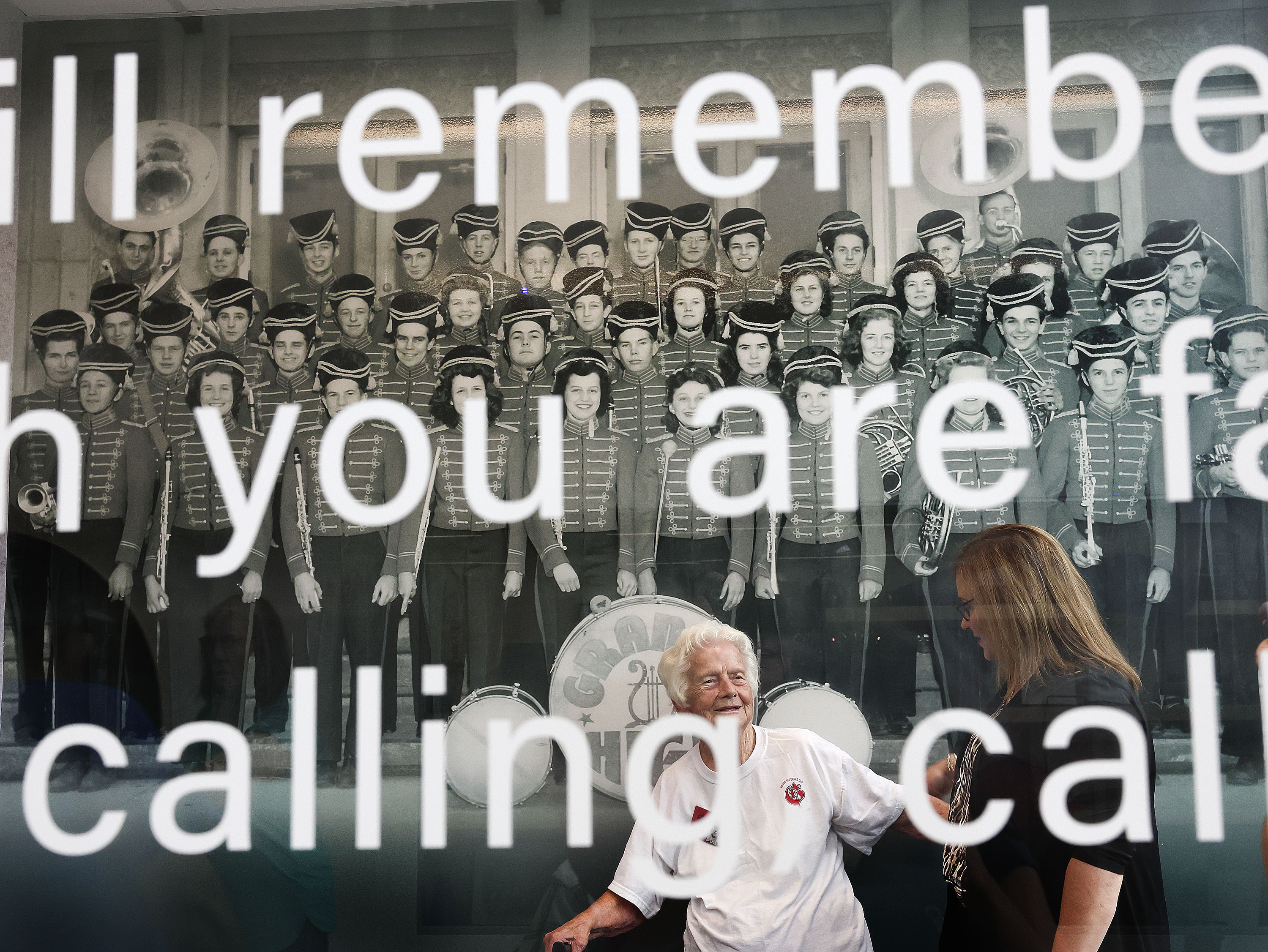 Ida Coombs Bickley, a 1944 graduate of Granite High School, chats with South Salt Lake Mayor Cherie Wood in the “Farmer’s Way” area of the Salt Lake County Library's Granite branch during the facility's grand opening in South Salt Lake on Friday. Coombs Bickley, a cymbal player, is in the photograph on the wall of the Granite High School marching band.