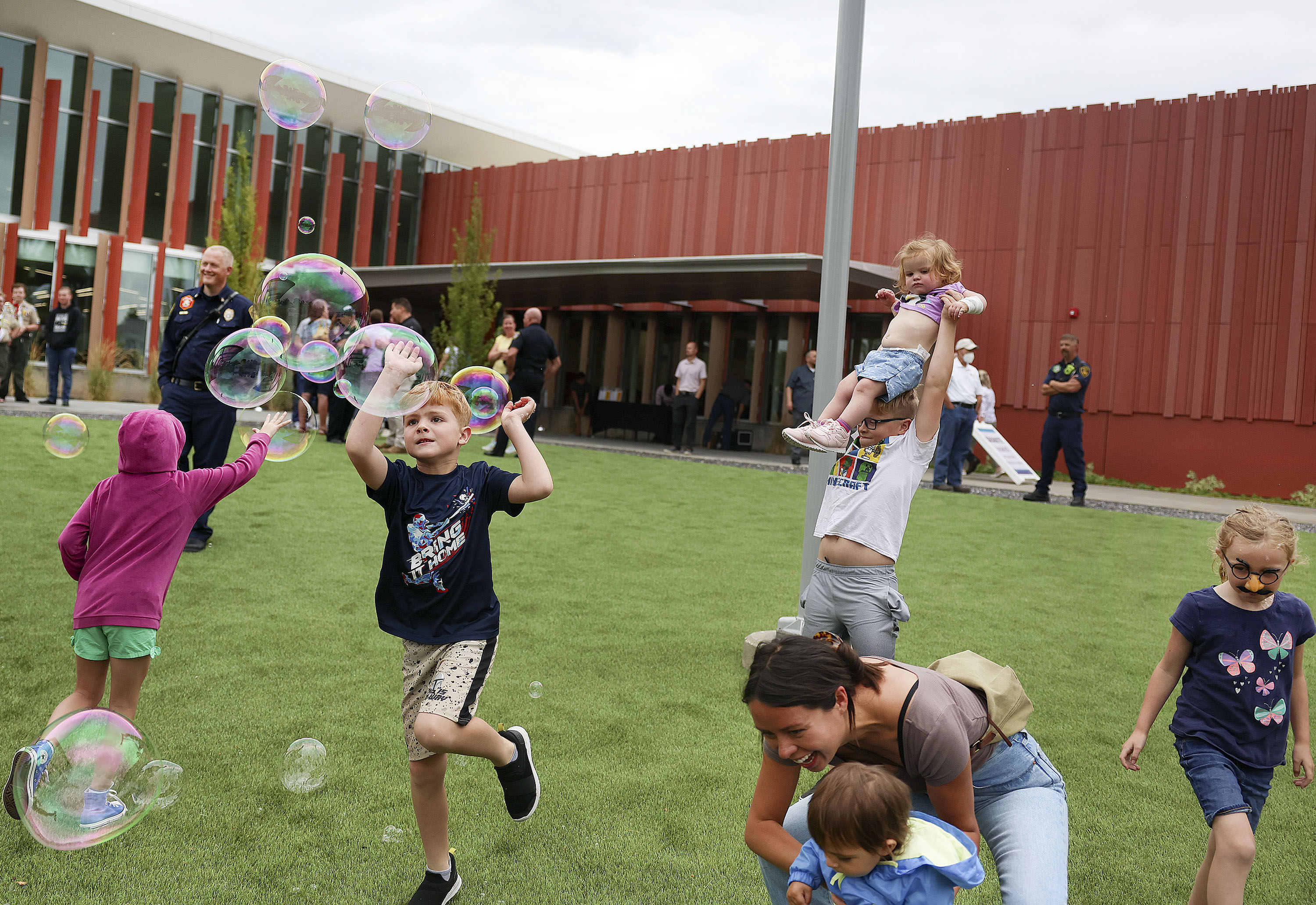 Children pop bubbles at the grand opening of the Salt Lake County Library’s Granite branch in South Salt Lake on Friday, July 15. Five years after the century-old Granite High School building was torn down, a new library emerges to keep the school's educational spirit alive.