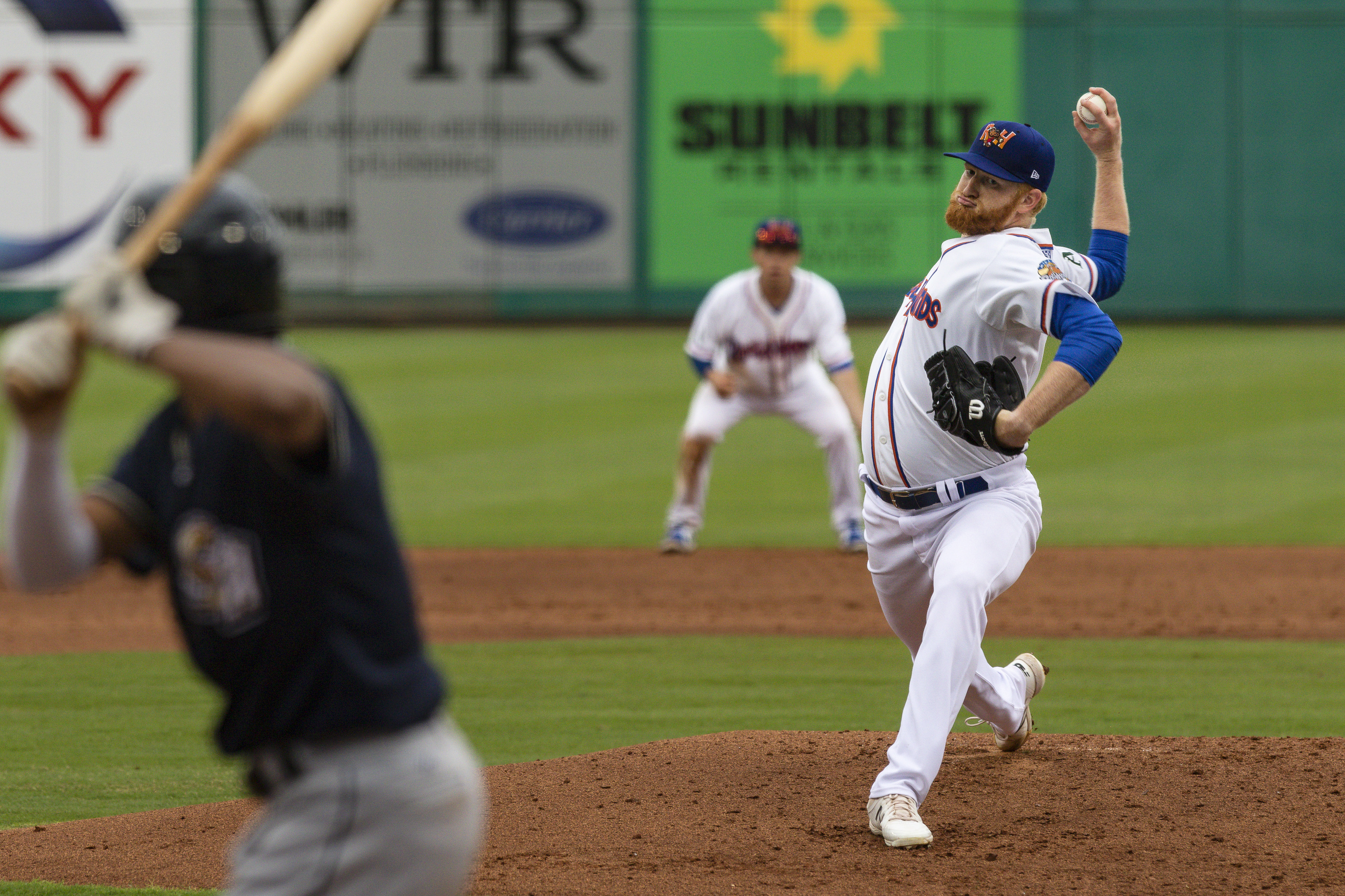 FILE - Midland RockHounds pitcher Brady Feigl throws during a Double-A baseball game against the San Antonio Missions on May 11, 2021, in Midland, Texas. Major League Baseball agreed to pay minor leaguers $185 million  to settle a federal lawsuit alleging violations of minimum wage laws, a case that progressed through the courts for eight years without reaching a trial. 