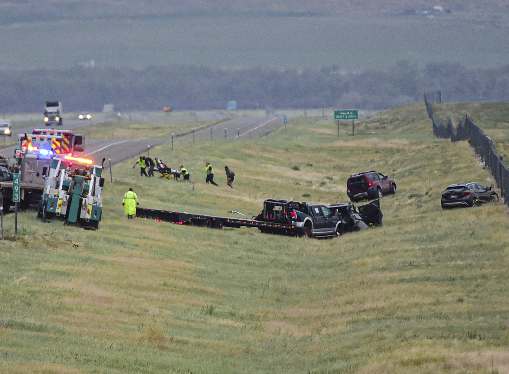 First responders work the scene on Interstate 90 after a fatal pileup where at least 20 vehicles crashed near Hardin, Mont., Friday. 
