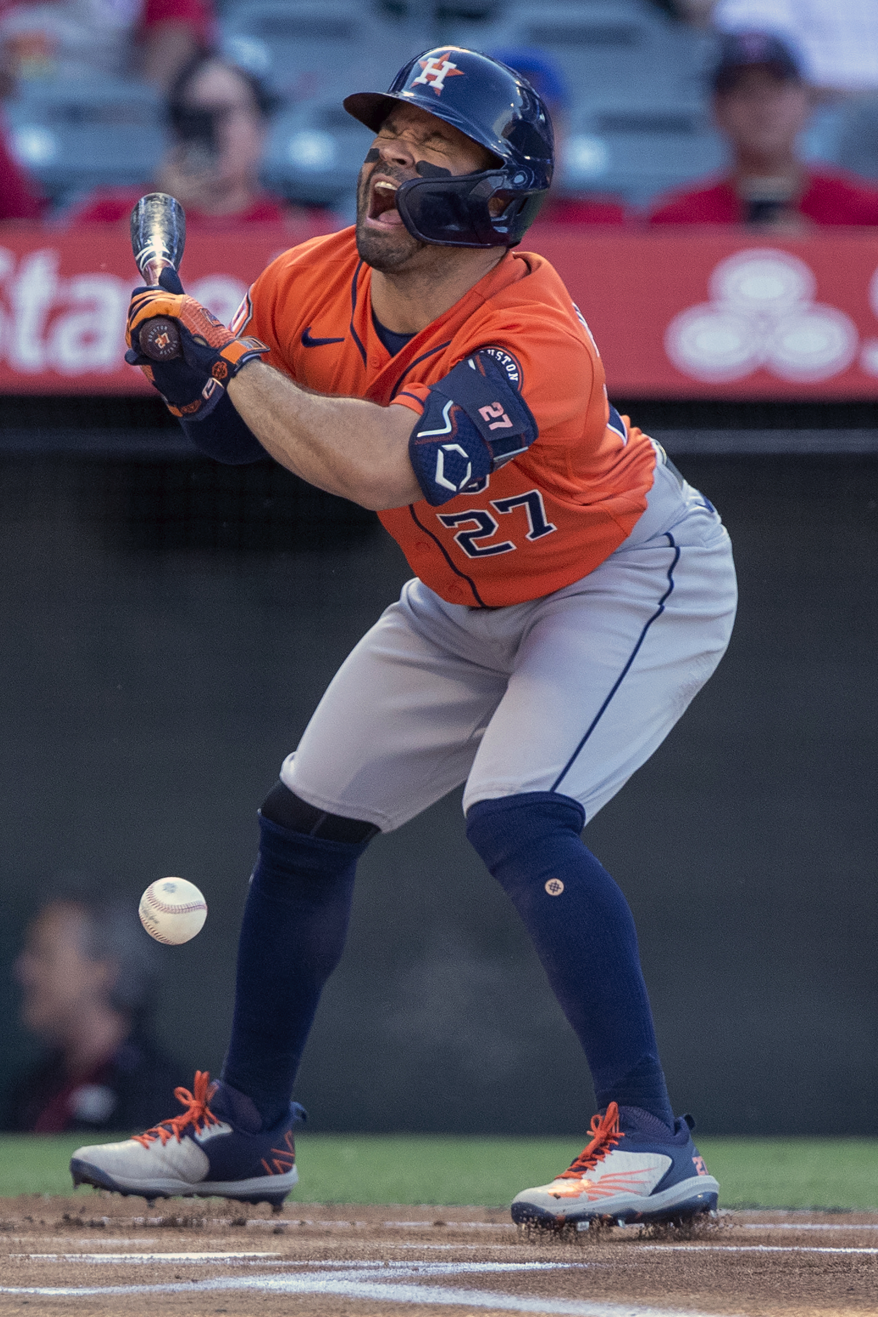 Houston Astros' Jose Altuve grimaces after being hit by a pitch during the first inning of the team's baseball game against the Los Angeles Angels in Anaheim, Calif., Thursday, July 14, 2022. 
