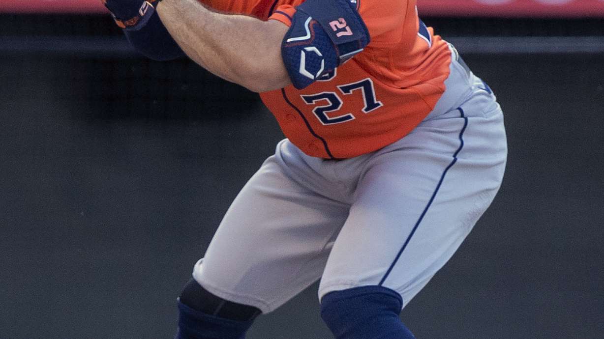 Houston Astros' Jose Altuve grimaces after being hit by a pitch during the first inning of the team's baseball game against the Los Angeles Angels in Anaheim, Calif., Thursday, July 14, 2022.