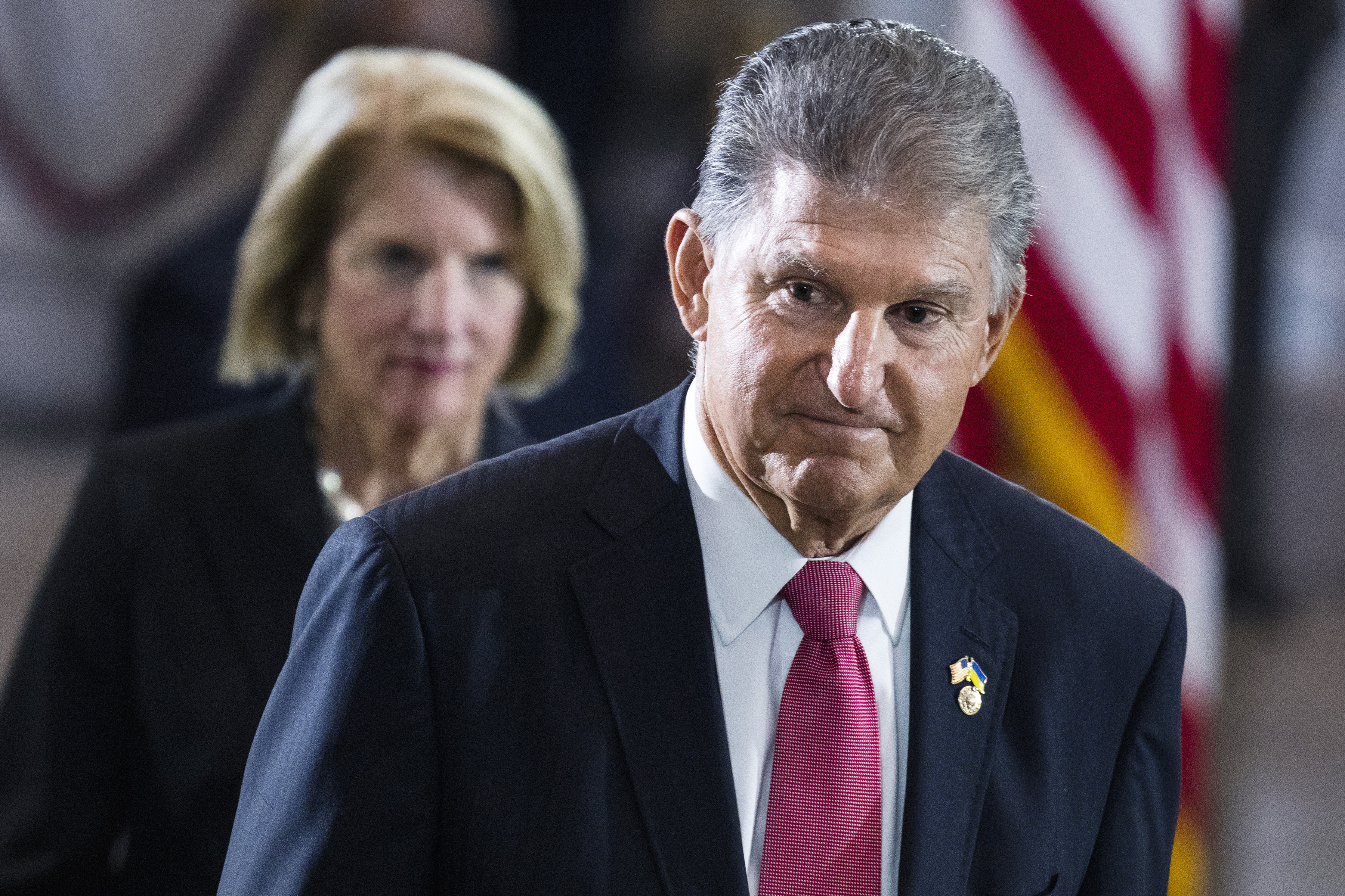 Sen. Joe Manchin, D-W.Va., and Sen. Shelley Moore Capito, R-W.Va., pay their respects as the flag-draped casket bearing the remains of Hershel W. "Woody" Williams, lies in honor in the U.S. Capitol, Thursday, July 14, 2022 in Washington. On Thursday Manchin said he wants to delay sweeping environmental legislation that Democrats have pushed as central to achieving President Joe Biden's ambitious climate goals.