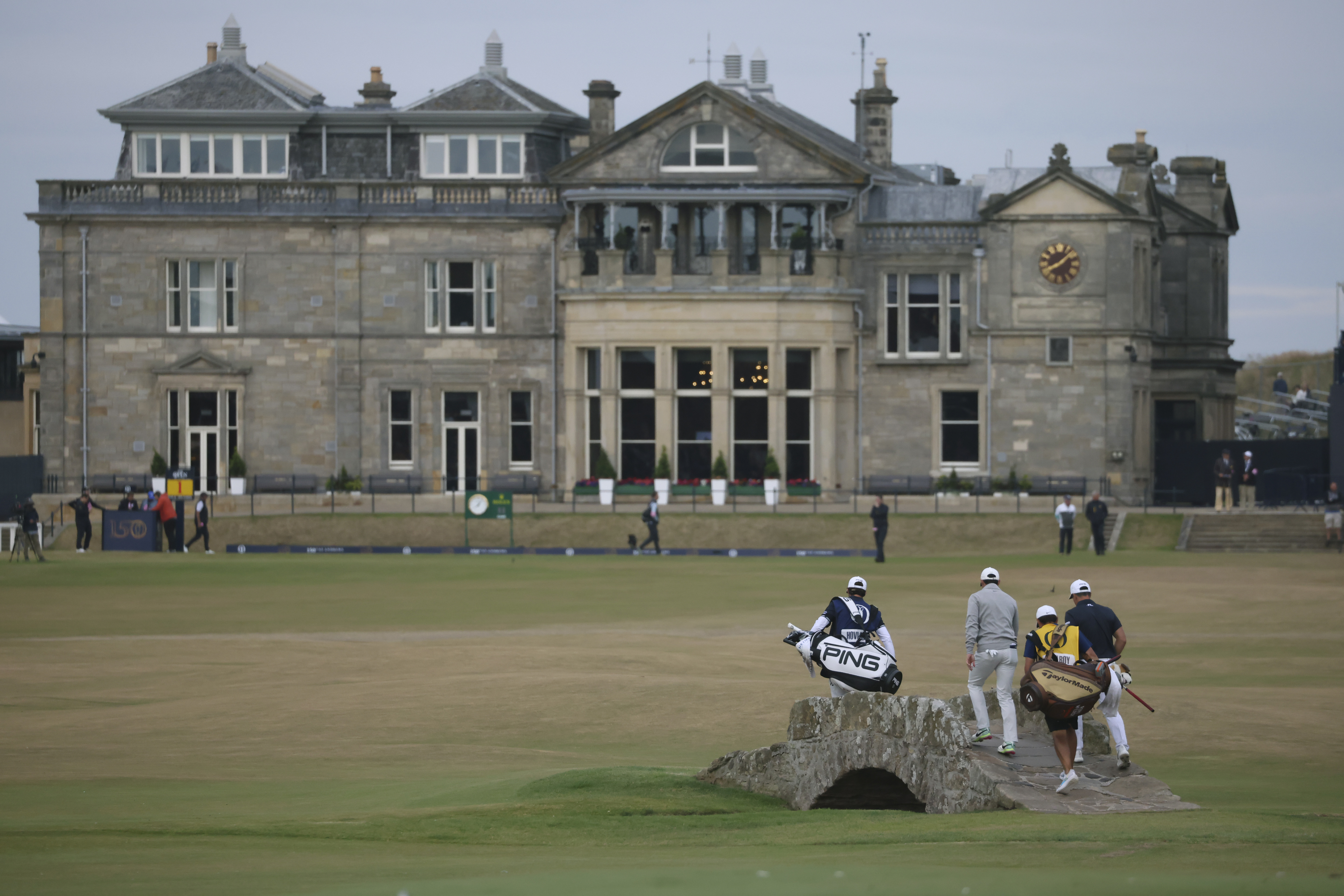 Rory McIlroy of Northern Ireland and Viktor Hovland, of Norway, right, cross the Swilken bridge on the 18th hole during the third round of the British Open golf championship on the Old Course at St. Andrews, Scotland, Saturday July 16, 2022. 