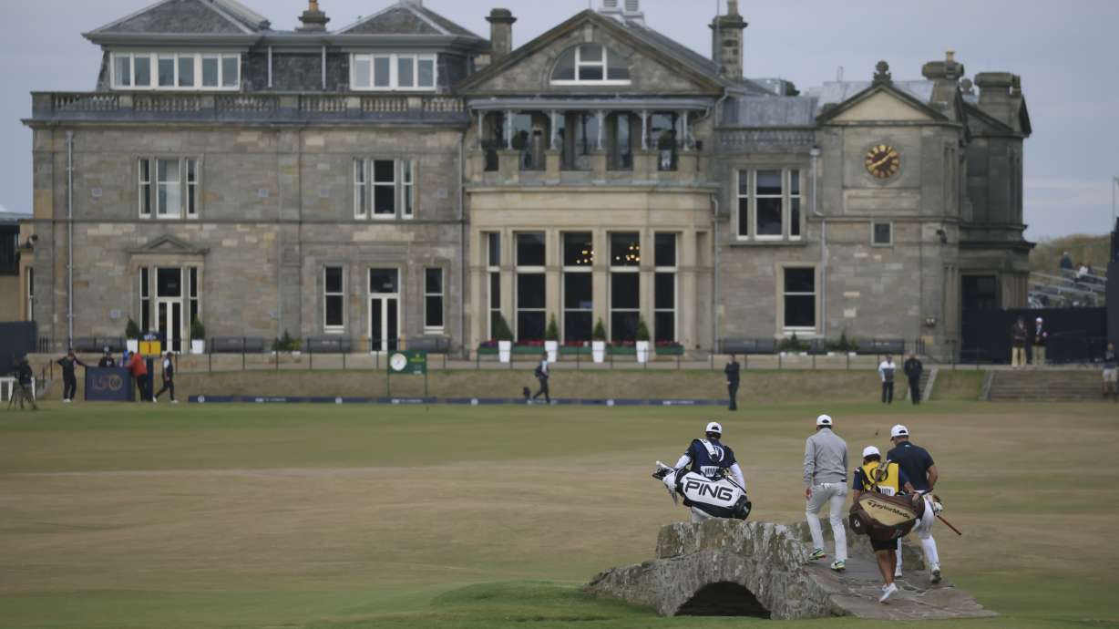 Rory McIlroy of Northern Ireland and Viktor Hovland, of Norway, right, cross the Swilken bridge on the 18th hole during the third round of the British Open golf championship on the Old Course at St. Andrews, Scotland, Saturday July 16, 2022.